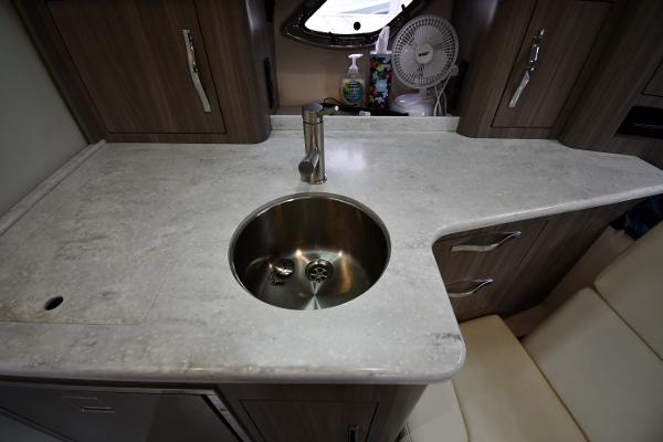 2021 Regal 35 Sport Coupe kitchen area with sink and countertop.