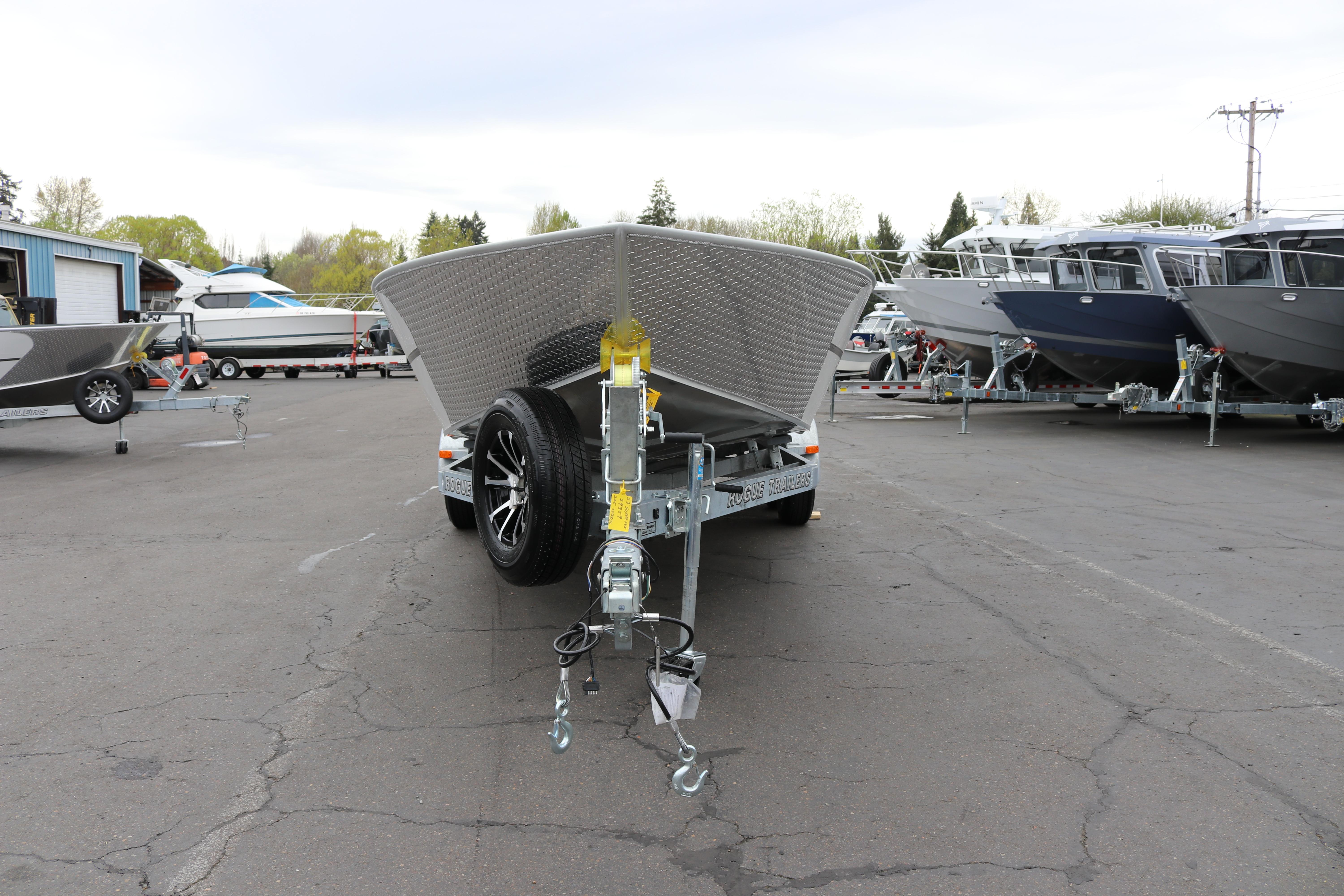 2026 Alumaweld Super Vee Pro 23 boat on trailer in parking lot.