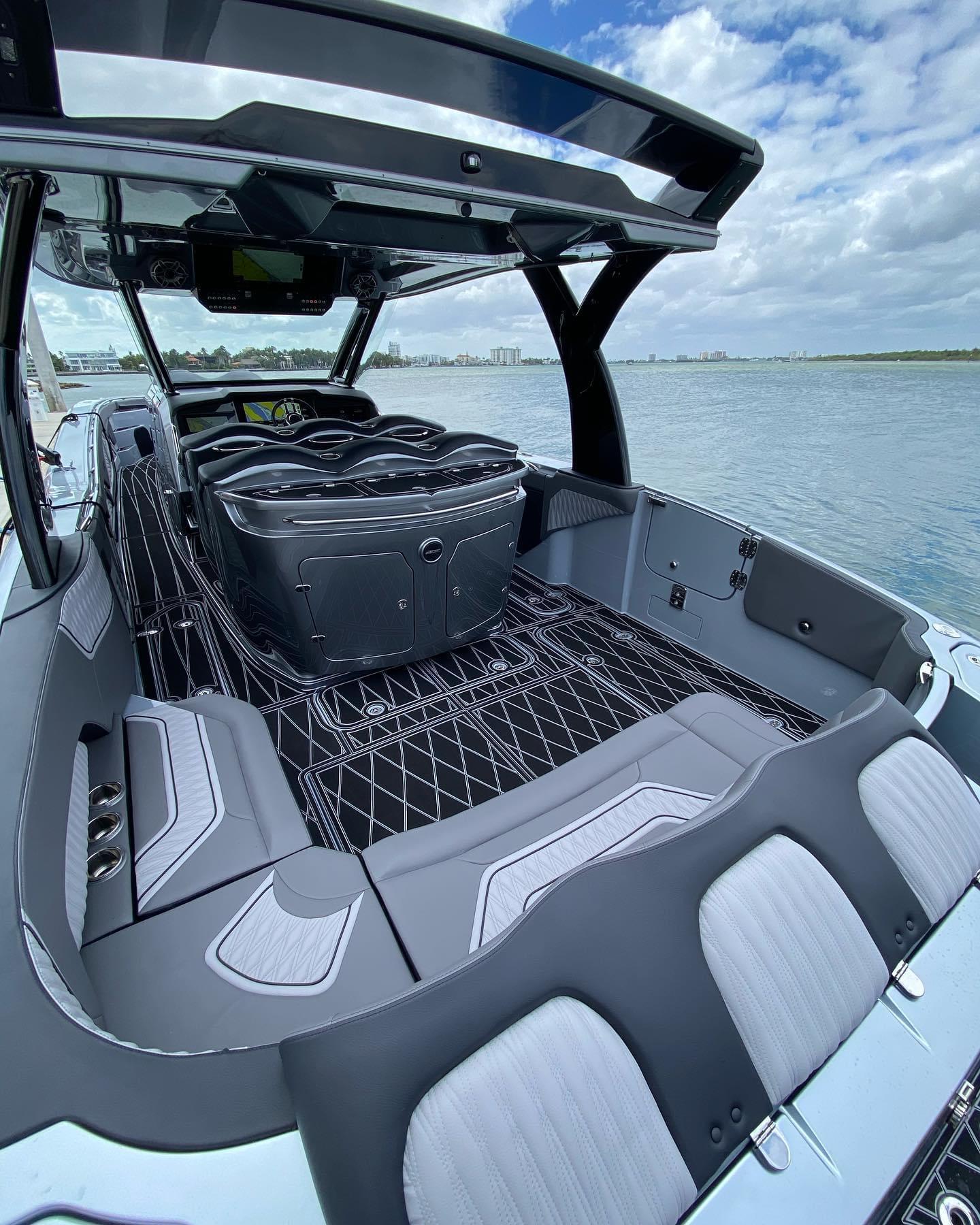2025 MTI V50 luxury speedboat interior with modern seating and sleek design on a sunny day.