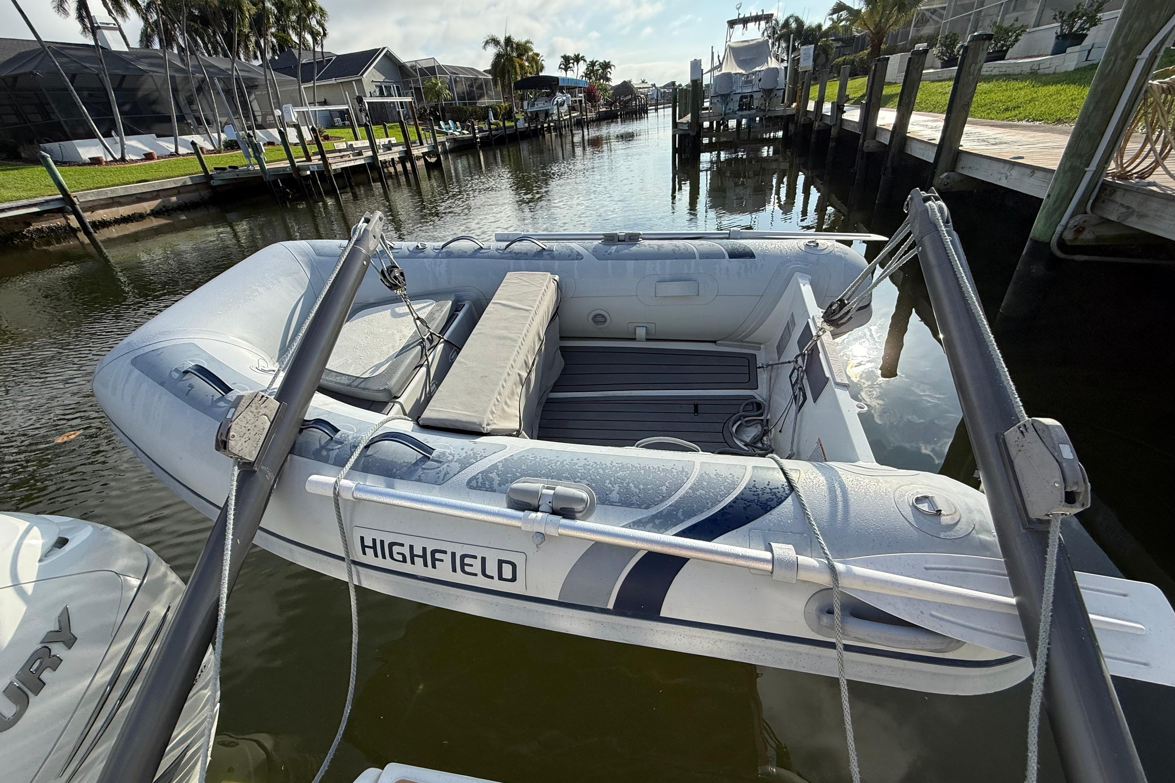 Aquila 36 Sport 2019 docked with inflatable Highfield boat in sunny marina.
