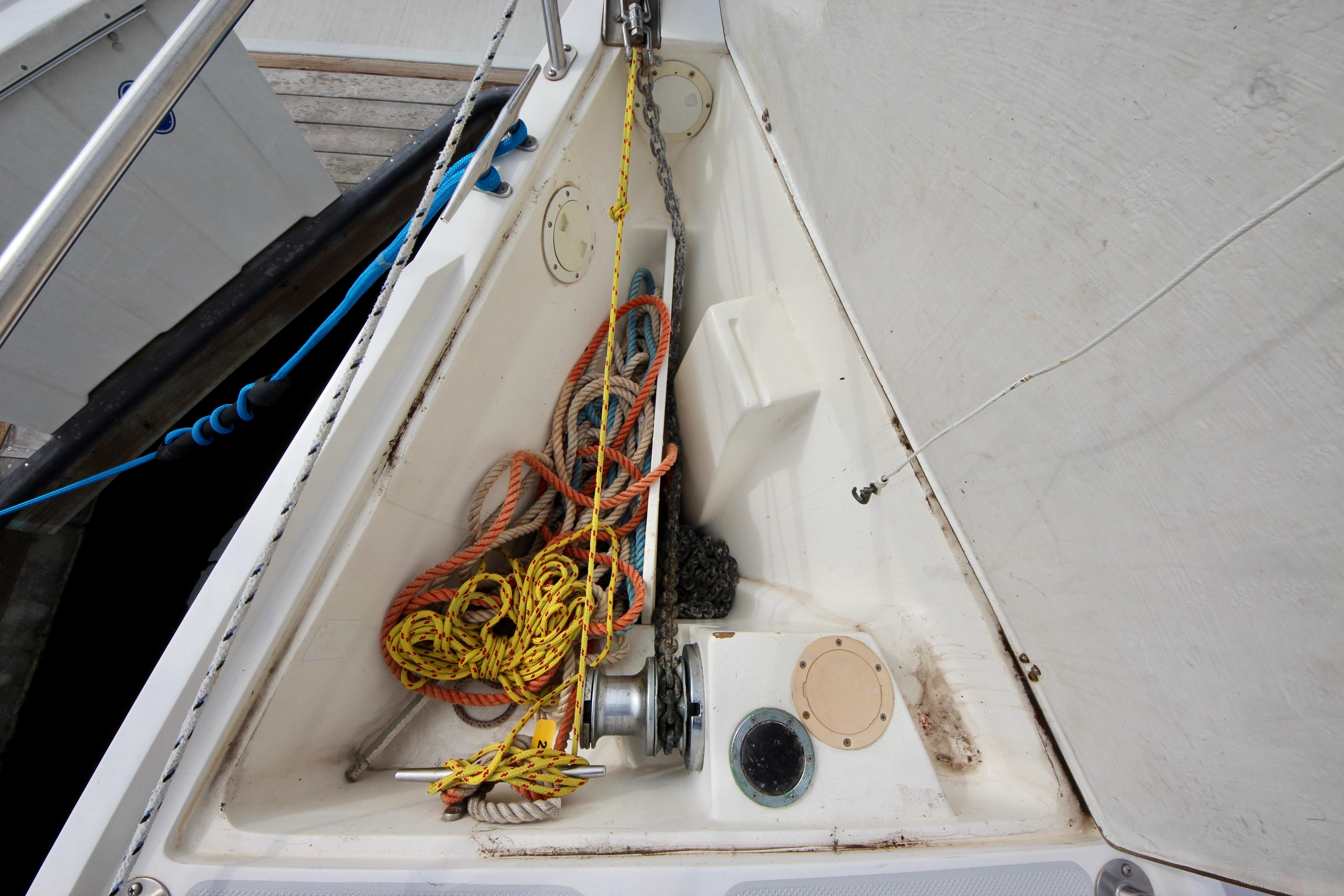 Anchor locker of a 1993 Catalina 42 MKI sailboat with ropes and chains.