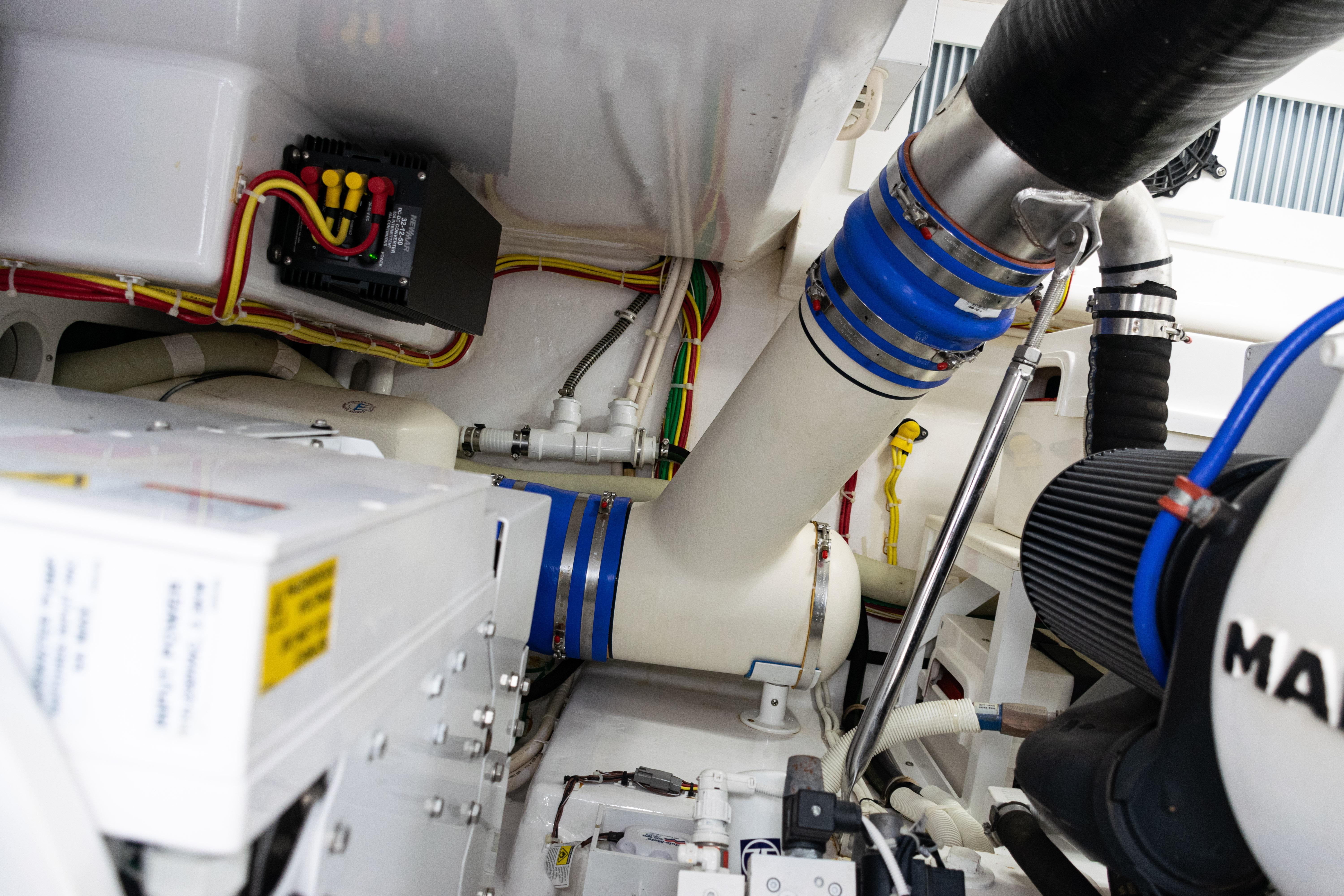Engine room of 2021 Viking 44 Open yacht, showcasing mechanical components and wiring.
