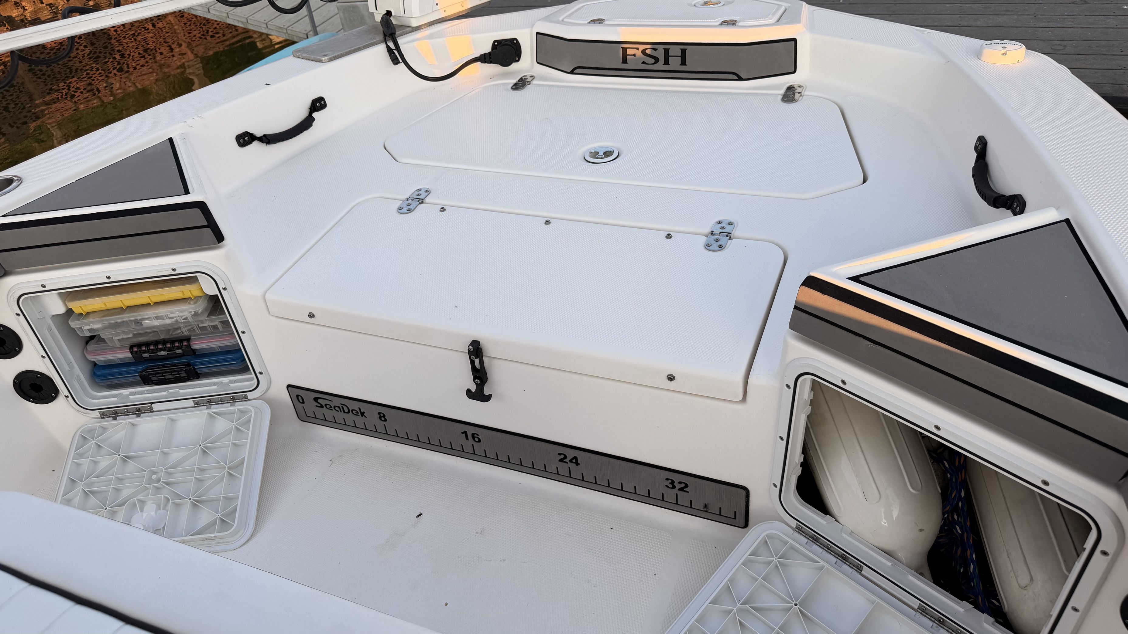 The image shows the cockpit of a 2019 Yamaha 190 FSH Sport boat with storage and a measuring scale.