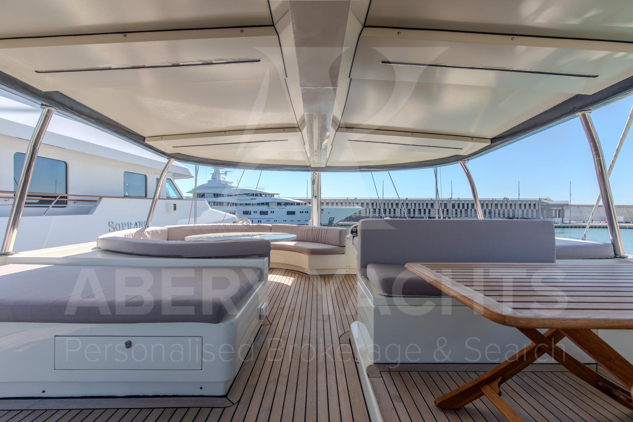 Luxurious 2011 Mural Yachts 28m deck with seating and dining area.