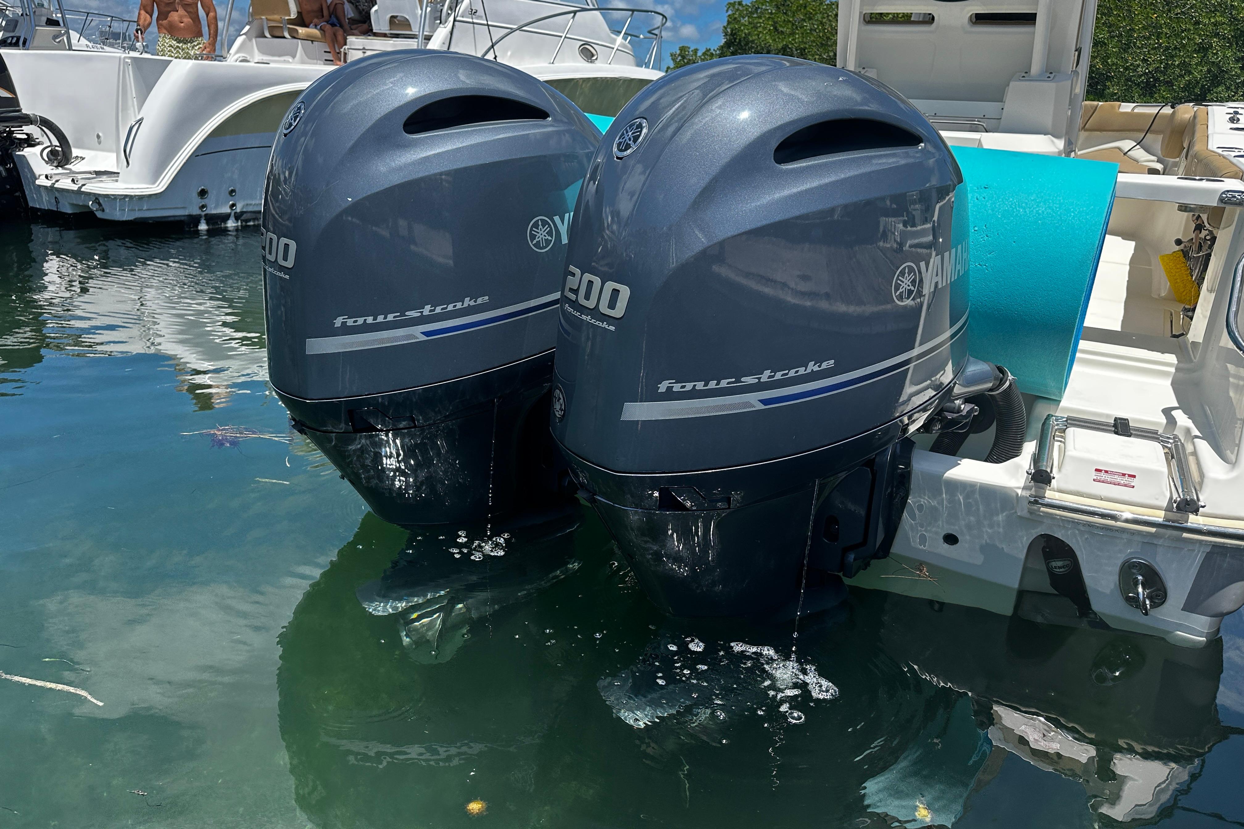 Twin Yamaha 200 four-stroke engines on a 2019 Pioneer 266 Pelagic boat in water.