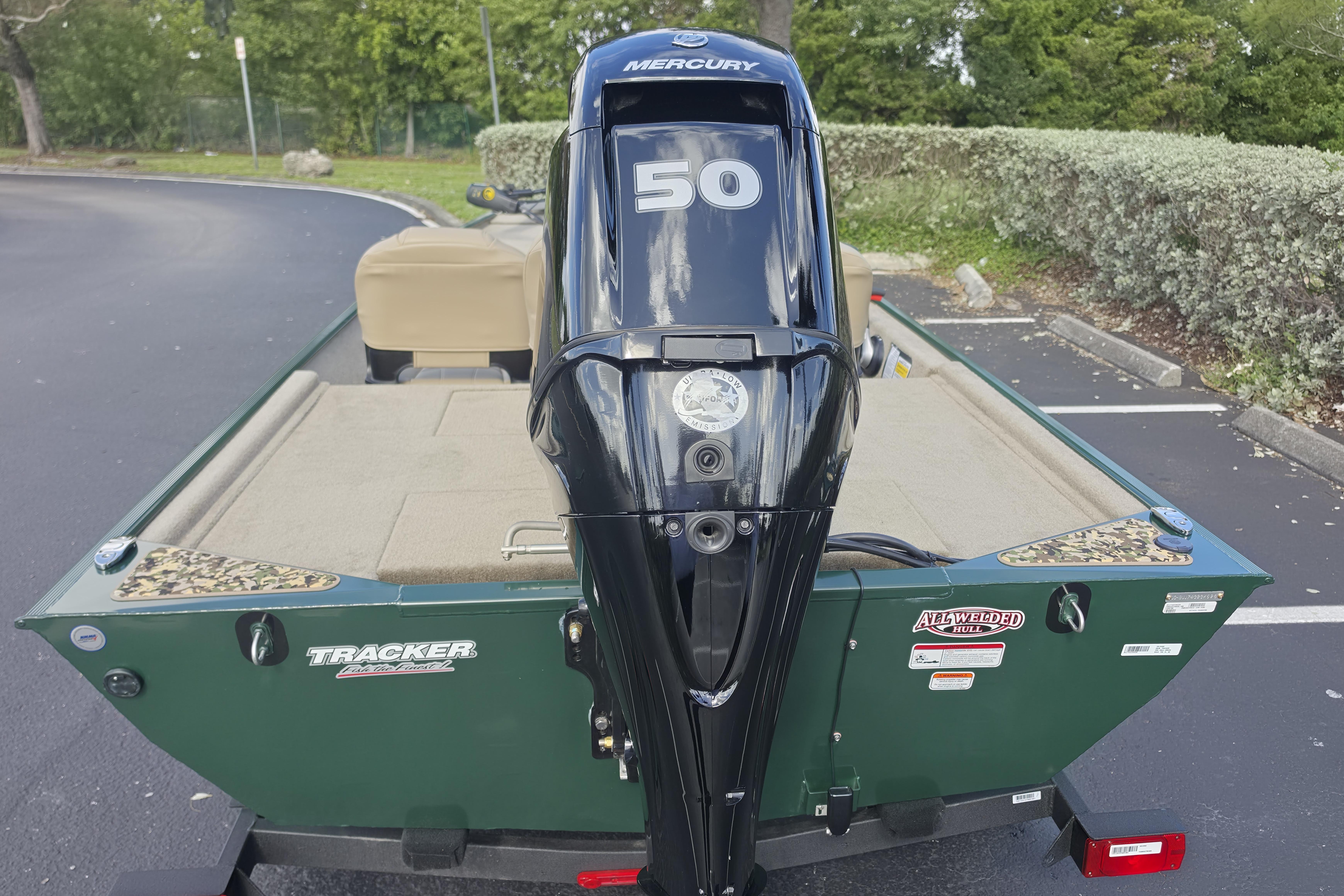 2026 Tracker Bass Tracker Classic Limited boat with Mercury 50 engine in parking lot.