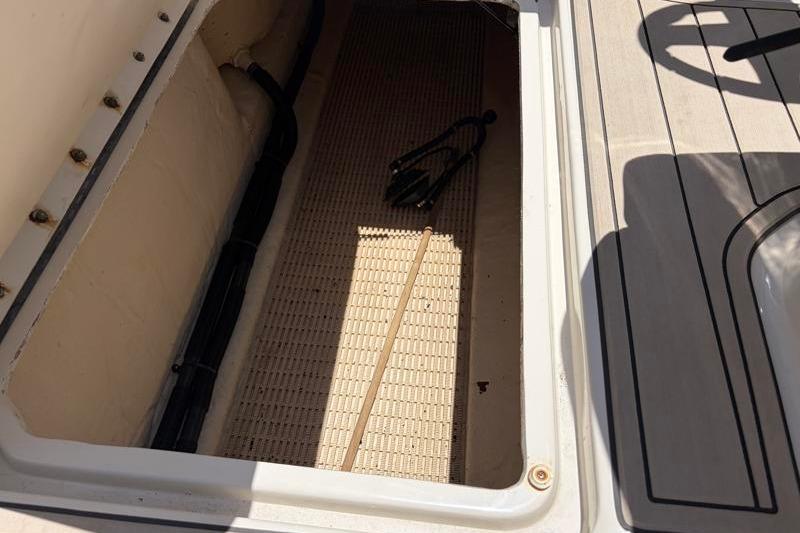Storage compartment of a 2007 Sea Ray 240 Sundeck boat, featuring interior details.