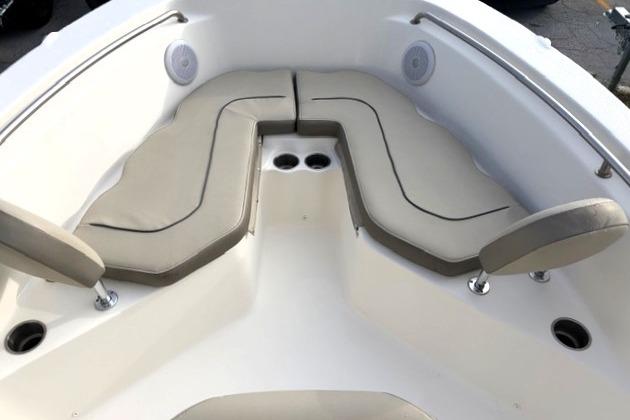 2023 Key West 203 FS boat interior with cushioned seating and cup holders.