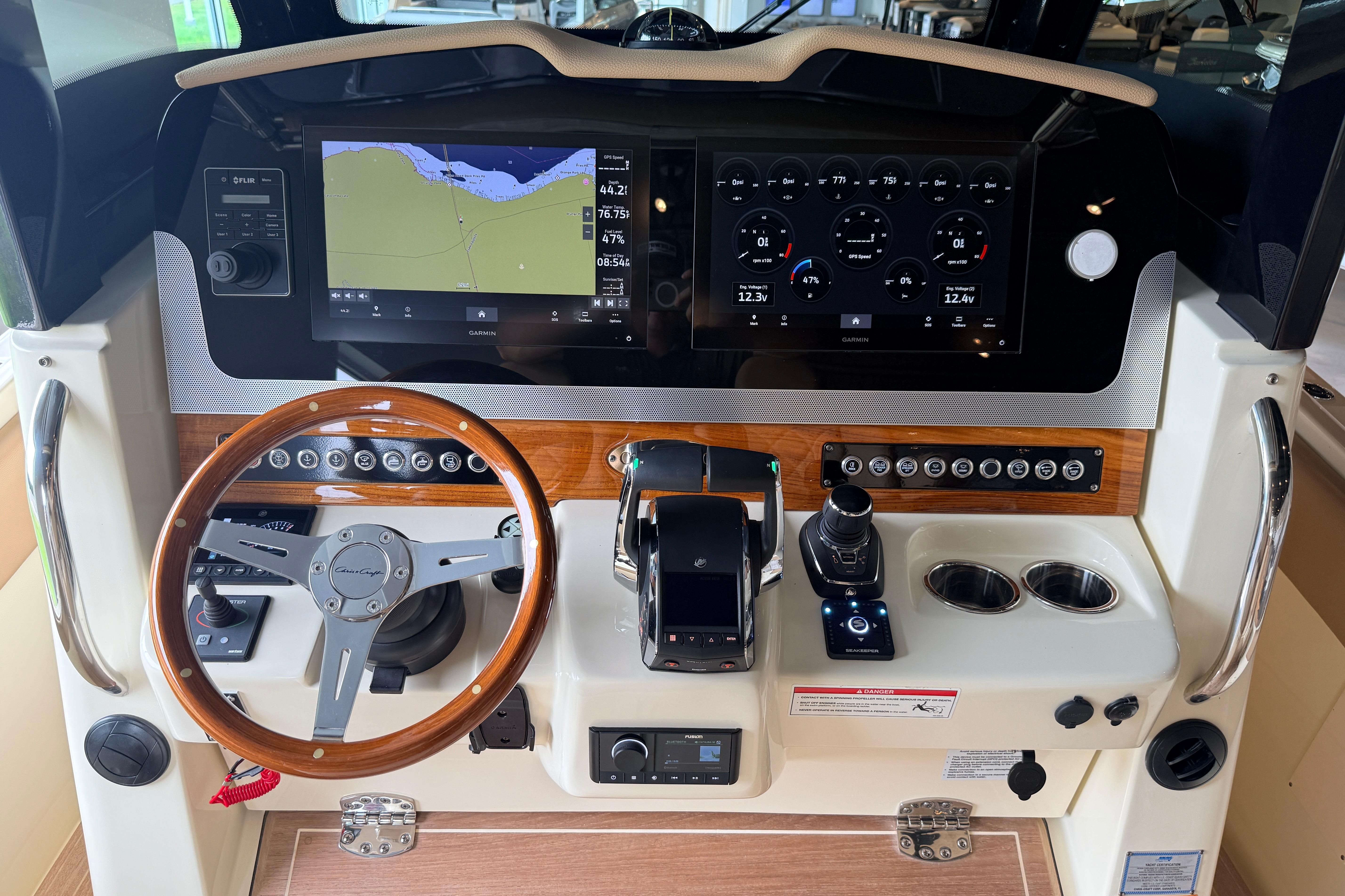 2024 Chris-Craft Catalina 30 helm with advanced navigation and control systems, featuring dual displays.