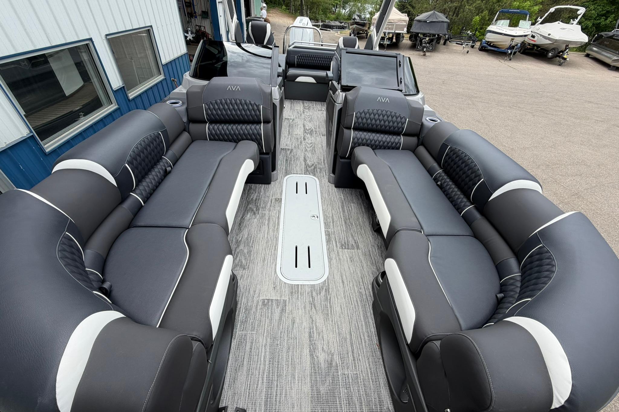Luxurious interior of 2026 Avalon Excalibur LTD Flex Lounge Windshield boat, featuring plush seating.