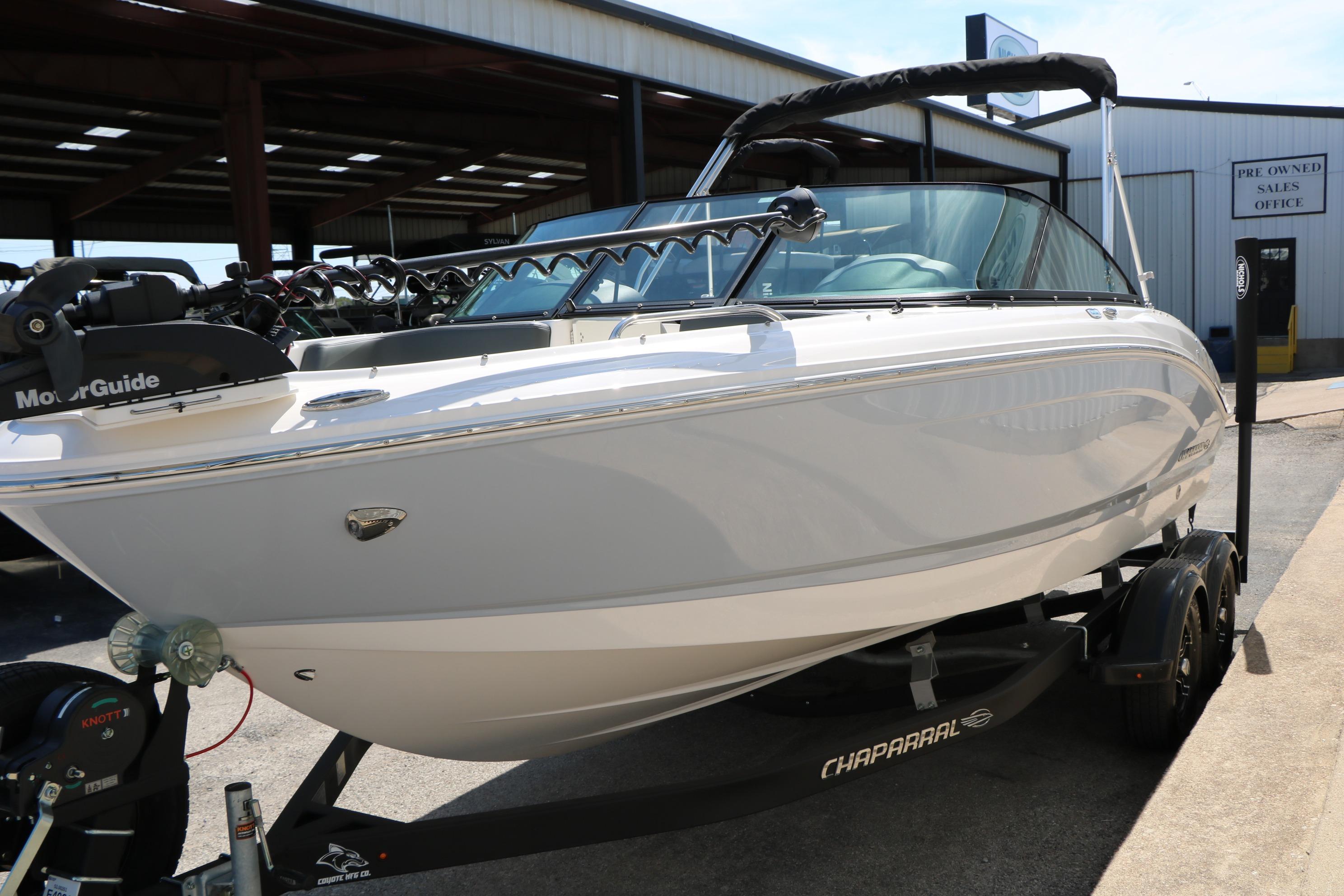 2025 Chaparral 21 SSi Ski & Fish boat on trailer, parked outdoors.