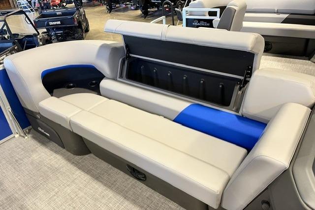 2026 Sun Tracker Party Barge 20 DLX pontoon boat seating with storage compartment open.
