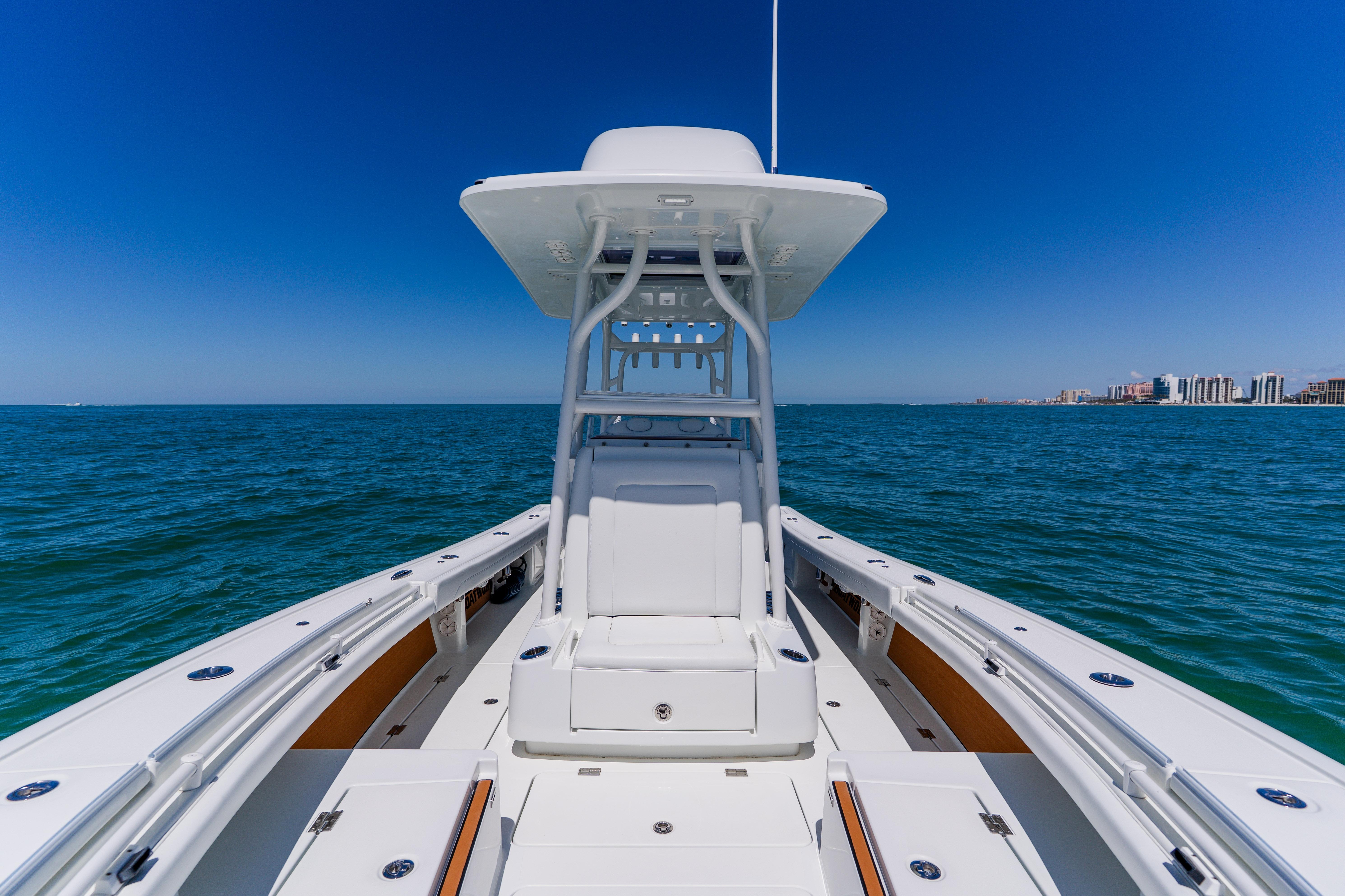 2017 Barker Boatworks 26 on open water with city skyline in background.