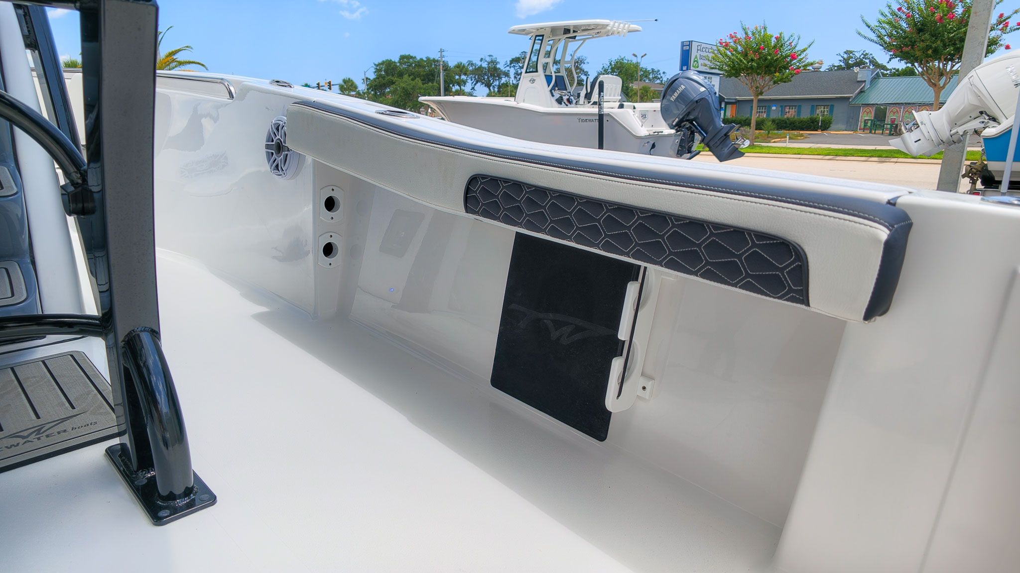 Interior view of a modern boat deck with sleek details and a speaker.
