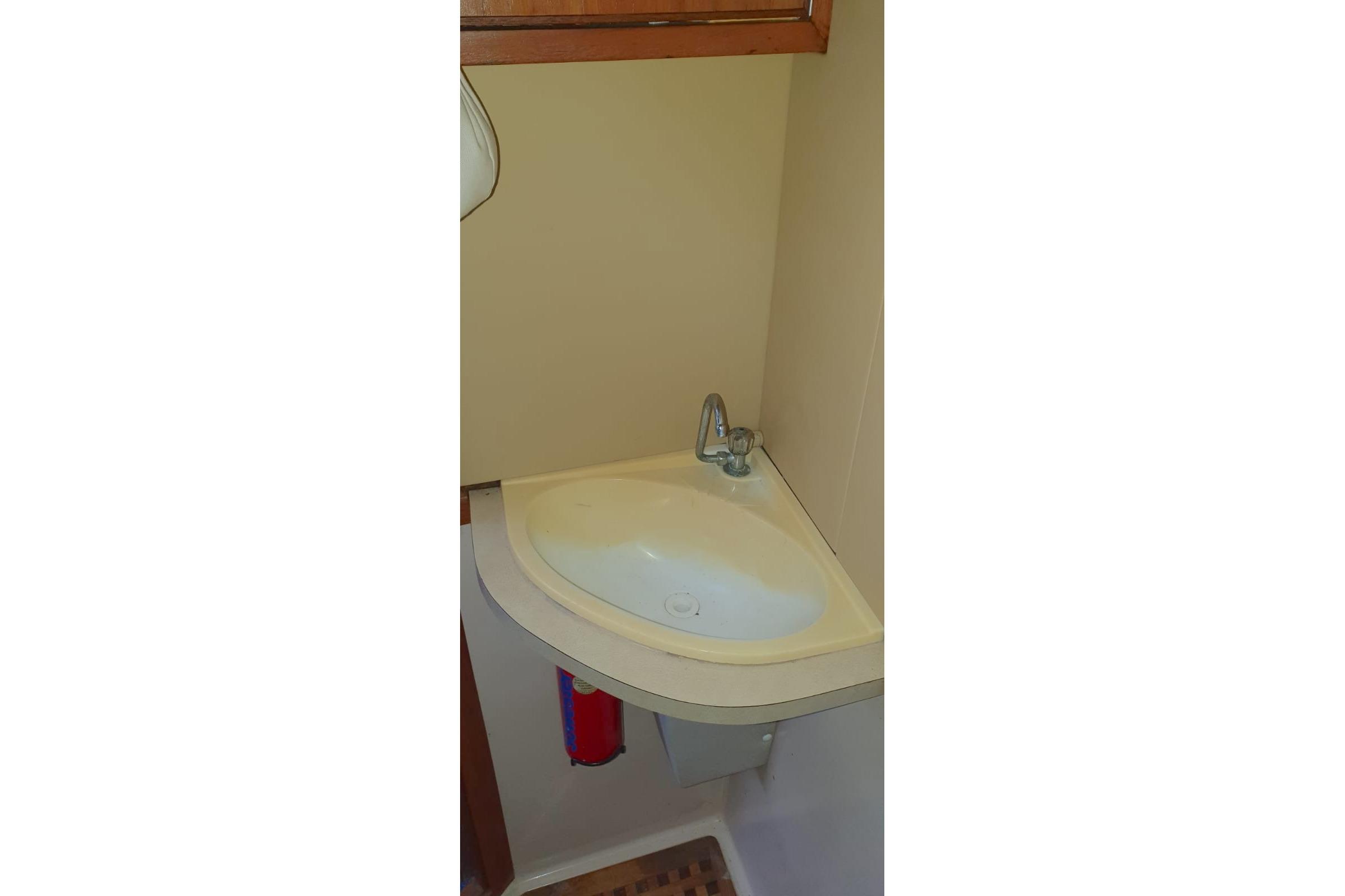 Compact corner sink in 1989 Fairey Spearfish MKIII boat bathroom.