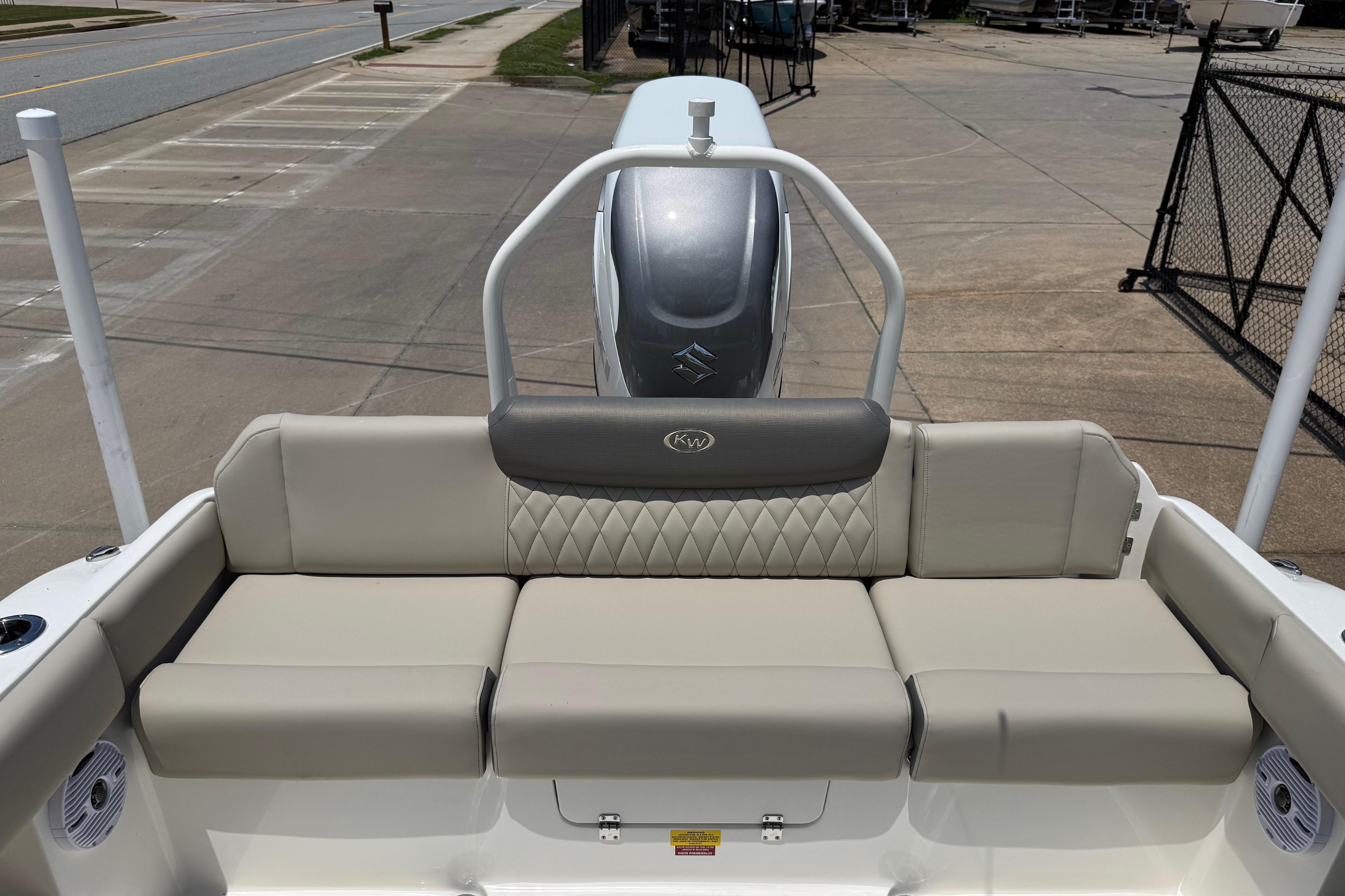 2027 Key West 249 FS boat interior with cushioned seating and motor view.