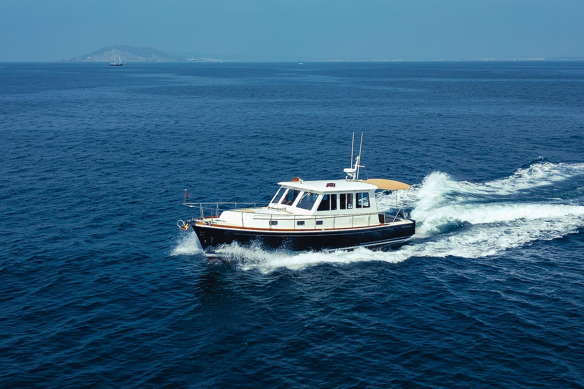 1998 Grand Banks 43 Eastbay EX cruising on open blue sea.