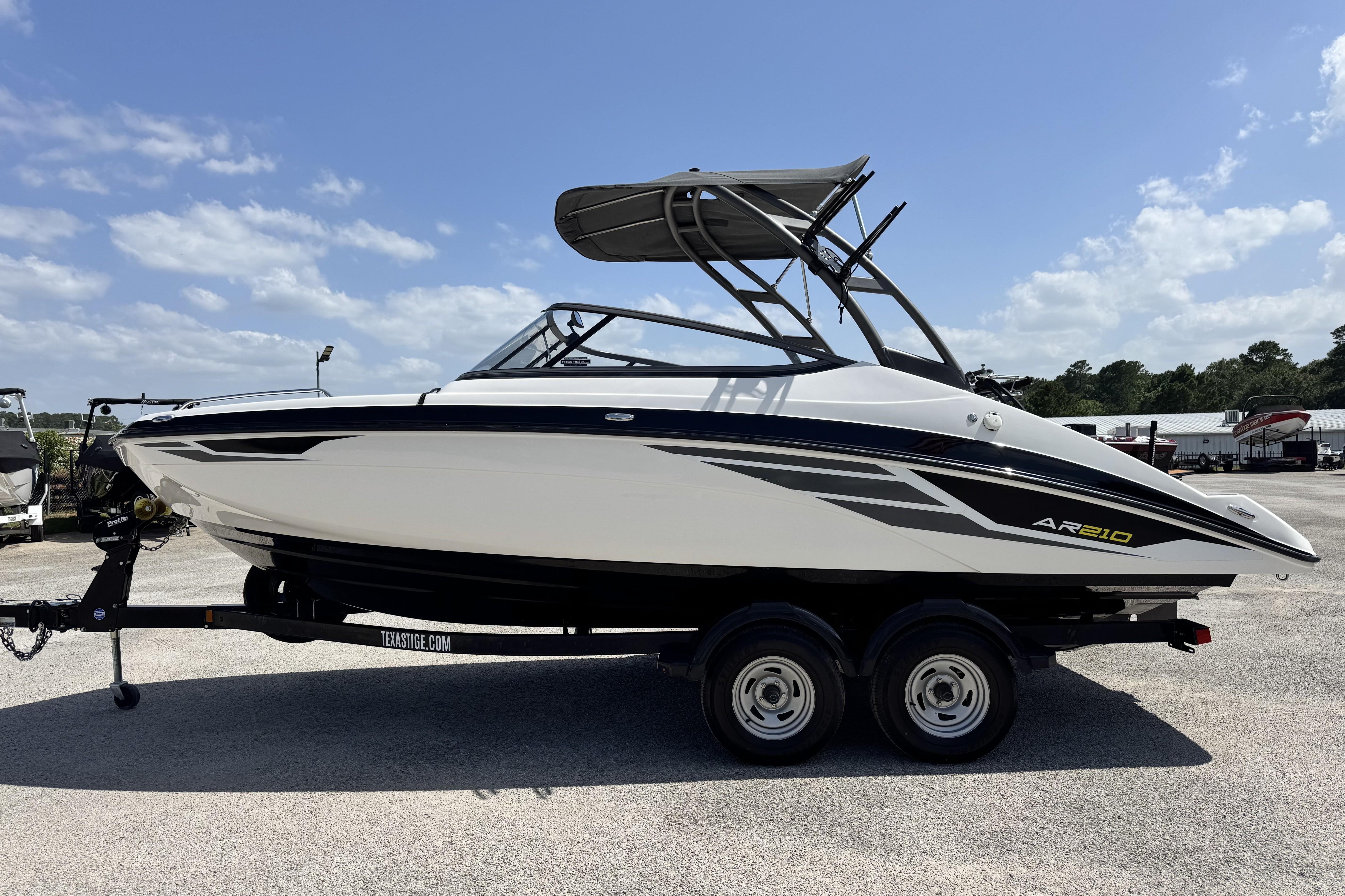 2018 Yamaha Boats AR210 on trailer under clear blue sky.