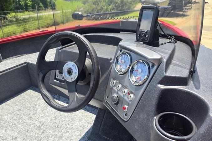 2026 Tracker Pro Guide V-16 SC boat dashboard with steering wheel and navigation system.