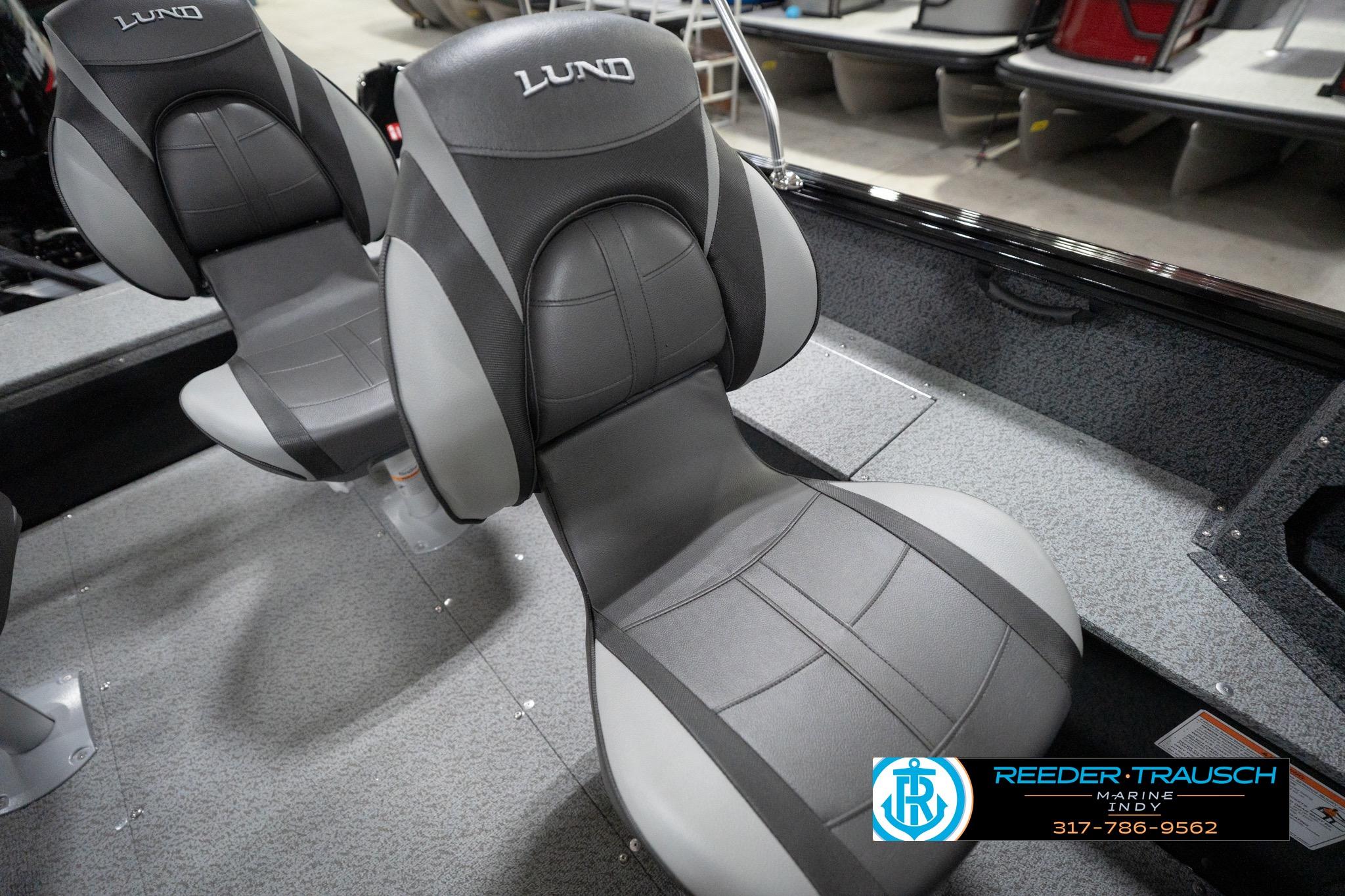 2026 Lund 1800 Explorer Sport boat seats, gray and black design, in showroom setting.