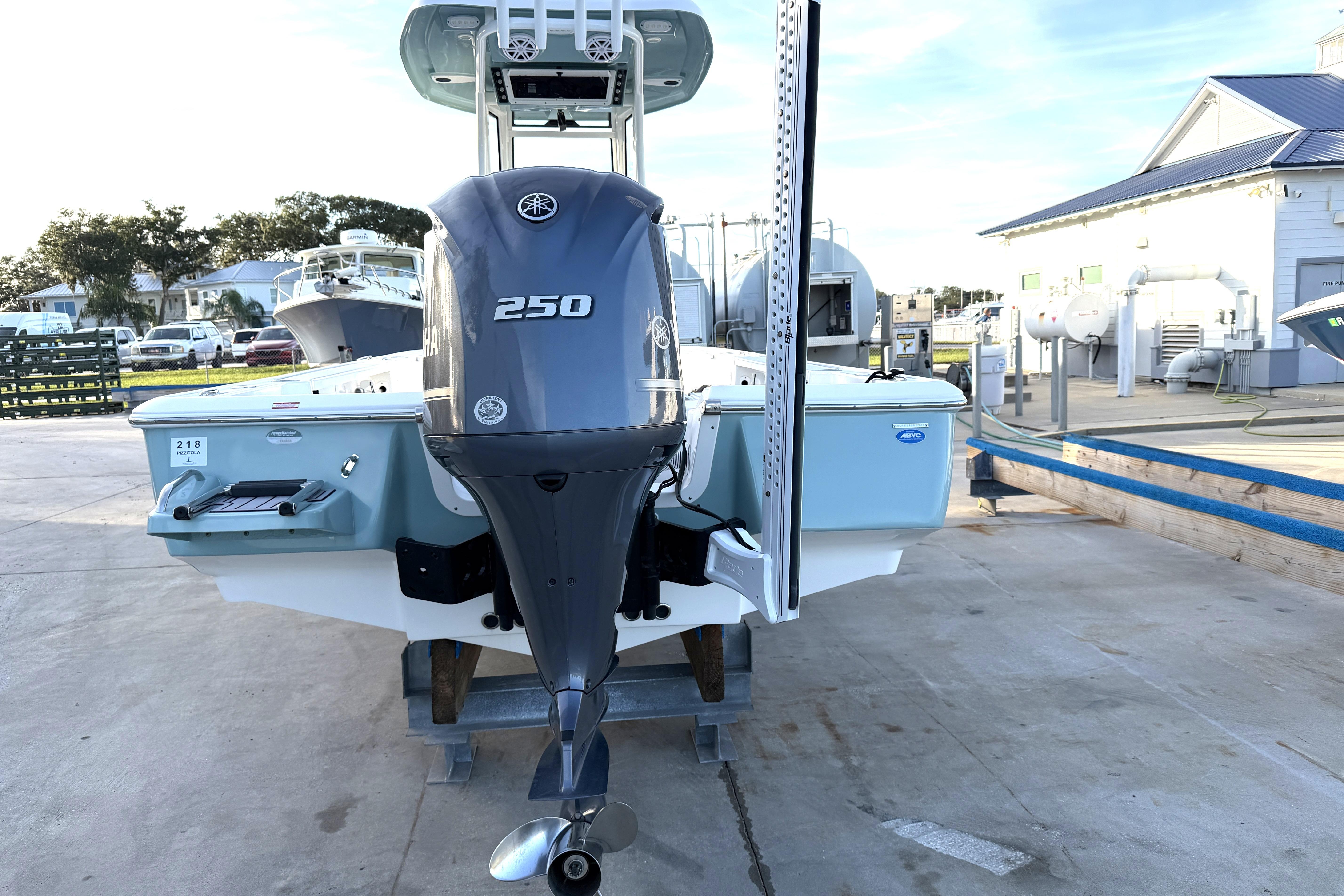 2023 Tidewater 2410 Bay Max boat with Yamaha 250 engine, docked outdoors.