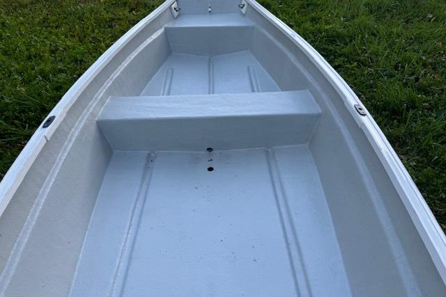 1999 Beacon Boats Pram interior, showing seating and hull design on grass.