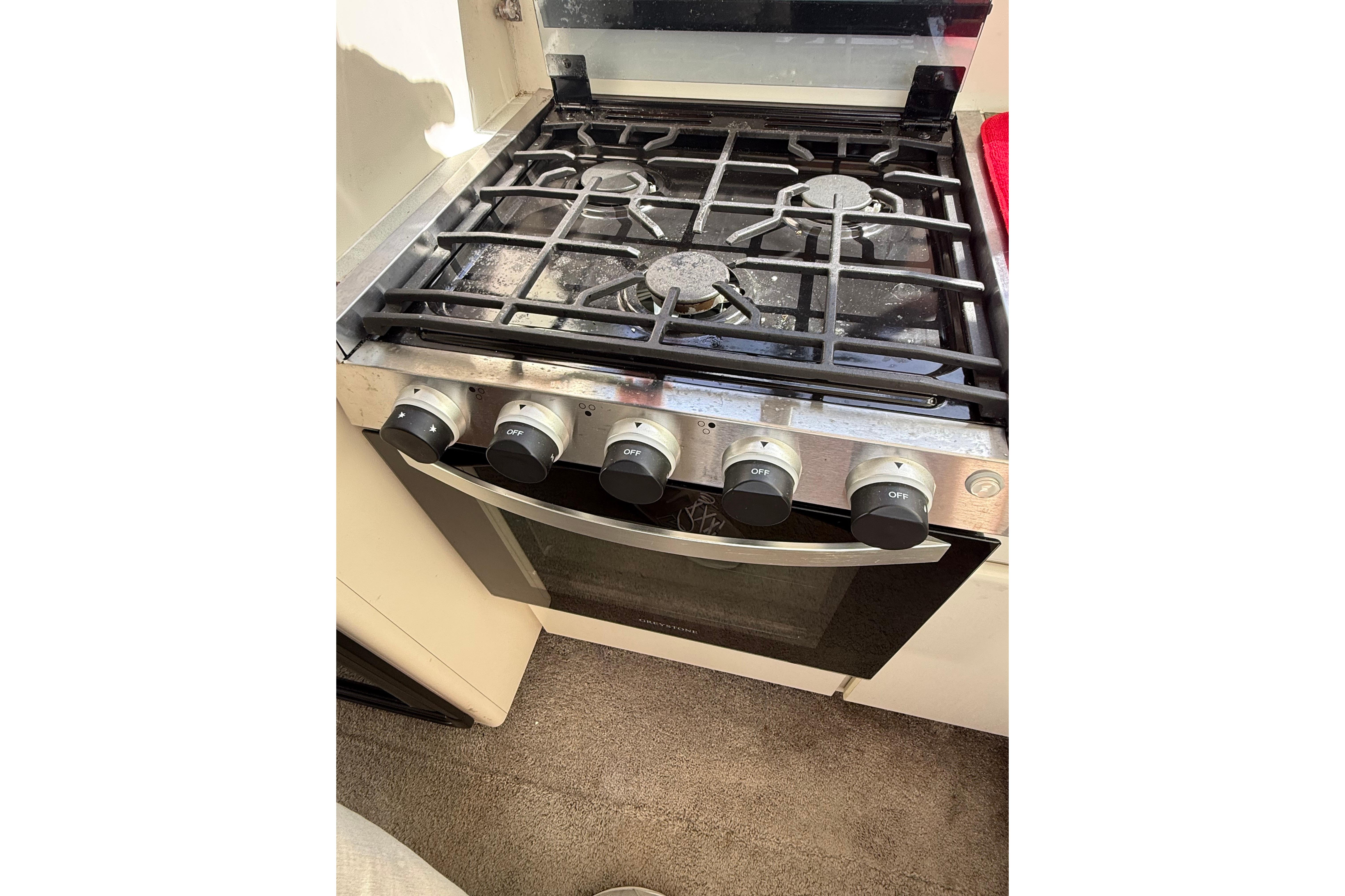 Stove with five burners in a 1995 Carver 370 Voyager yacht kitchen.