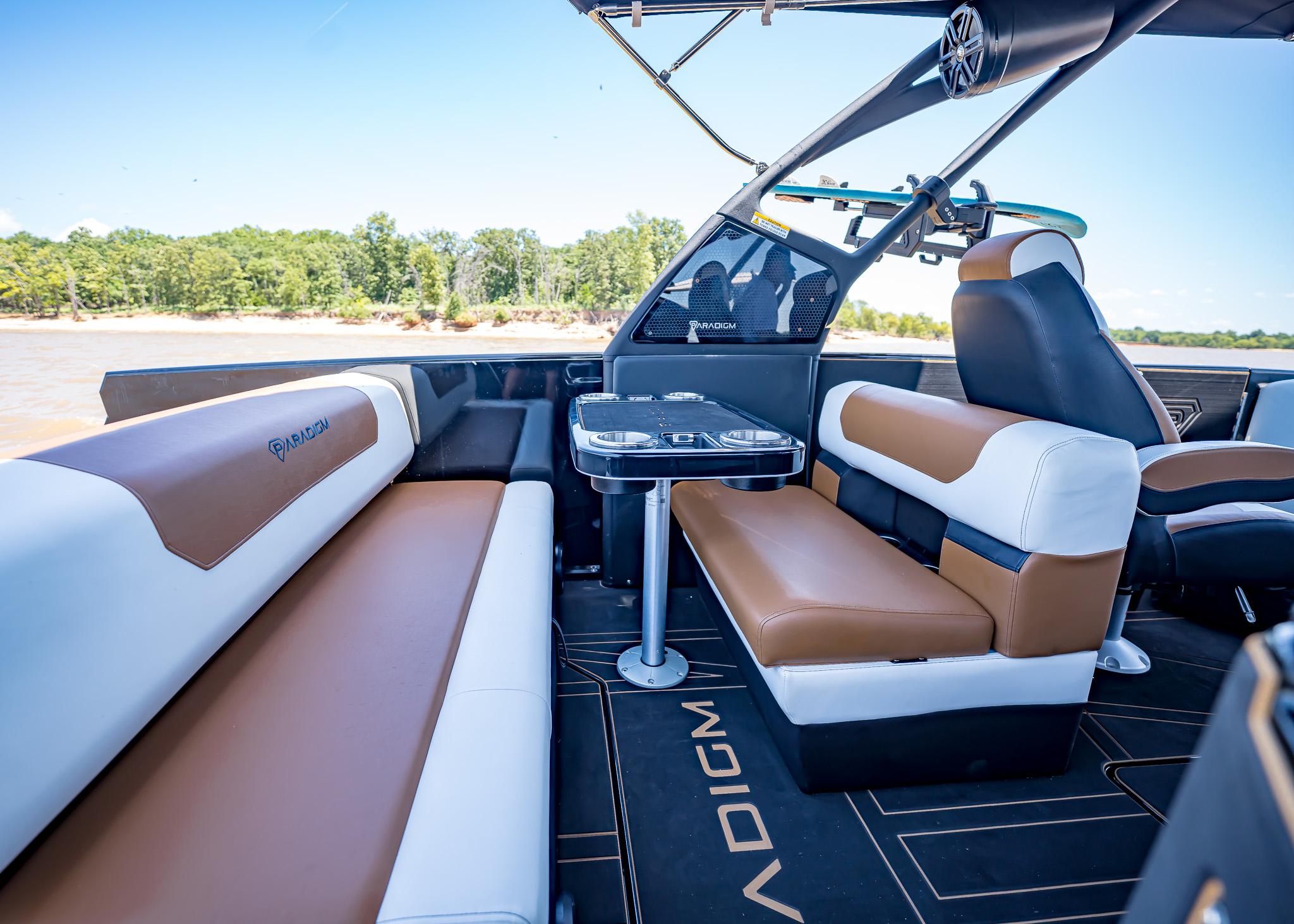 Luxurious interior of 2025 Paradigm 236 boat with stylish seating and table.