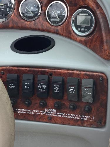Control panel of a 1998 Chaparral 2335 SS boat with various switches and gauges.