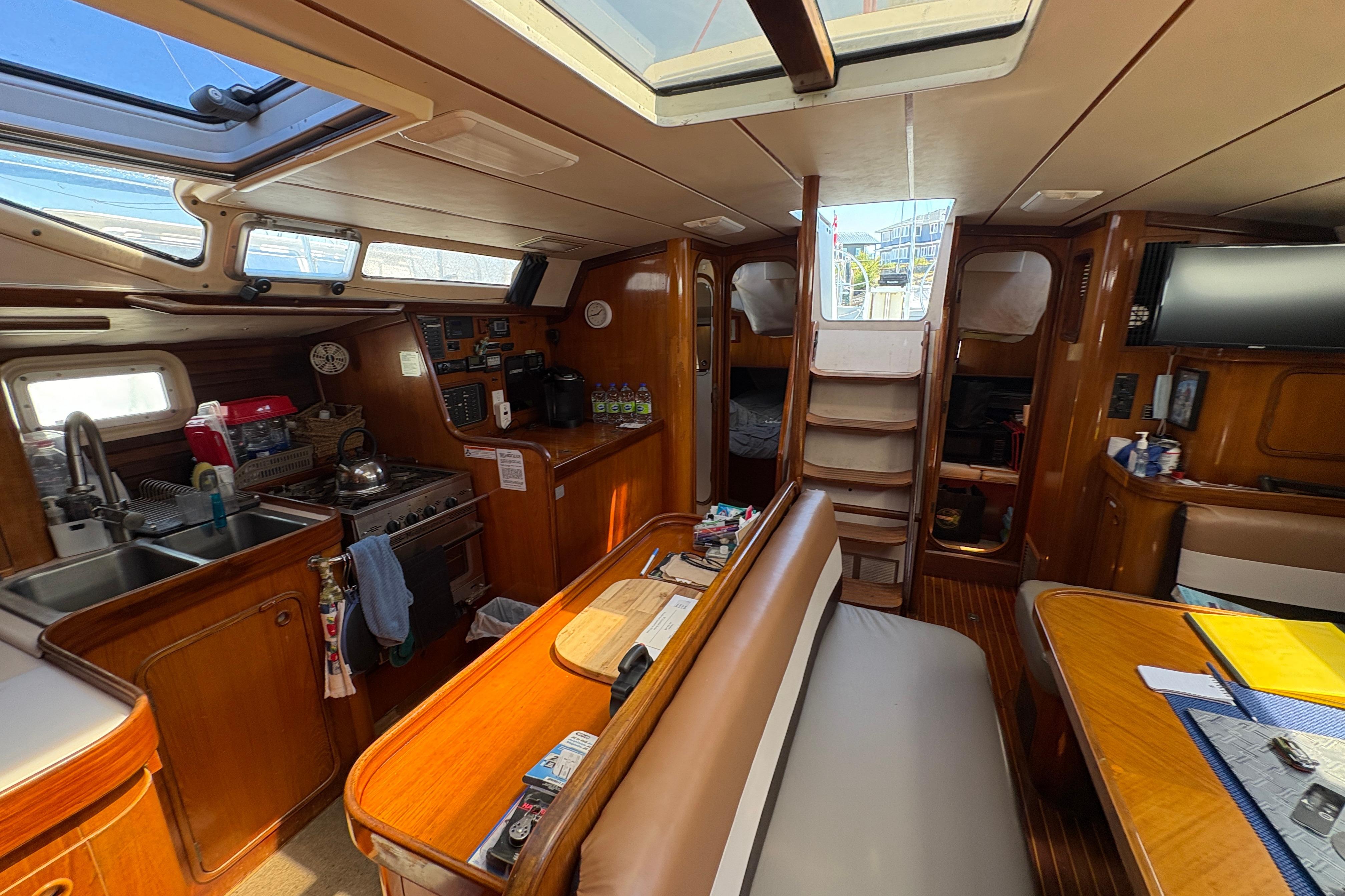 Interior of 1990 Beneteau Oceanis 500 sailboat with kitchen and seating area.