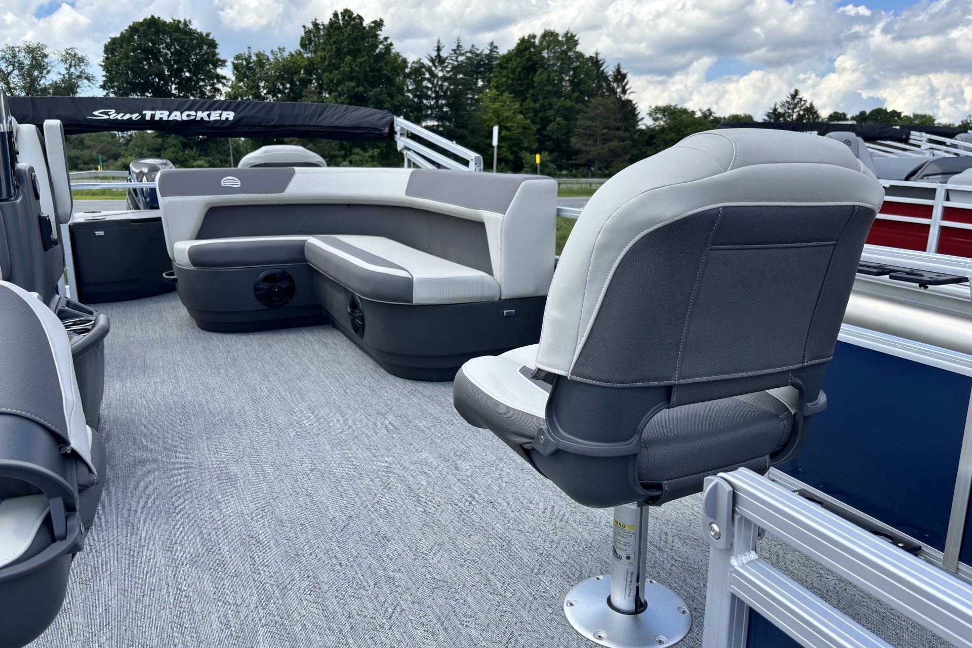 2026 Sun Tracker Bass Buggy 18 DLX pontoon boat interior with seating and carpeted floor.