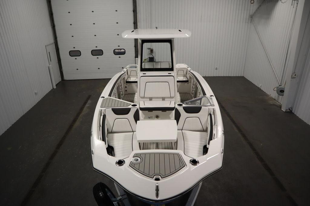 2026 Yamaha Boats 255 FSH Sport E in a spacious indoor showroom.