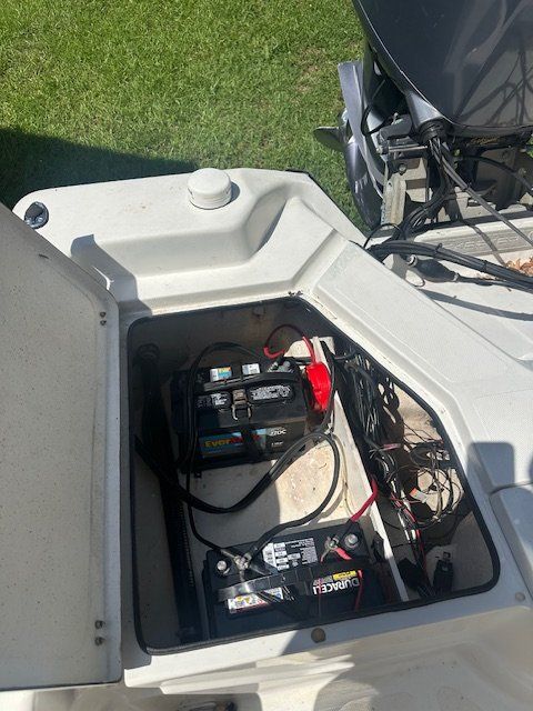 Battery compartment of a 2003 Skeeter ZX2200 boat with two batteries.