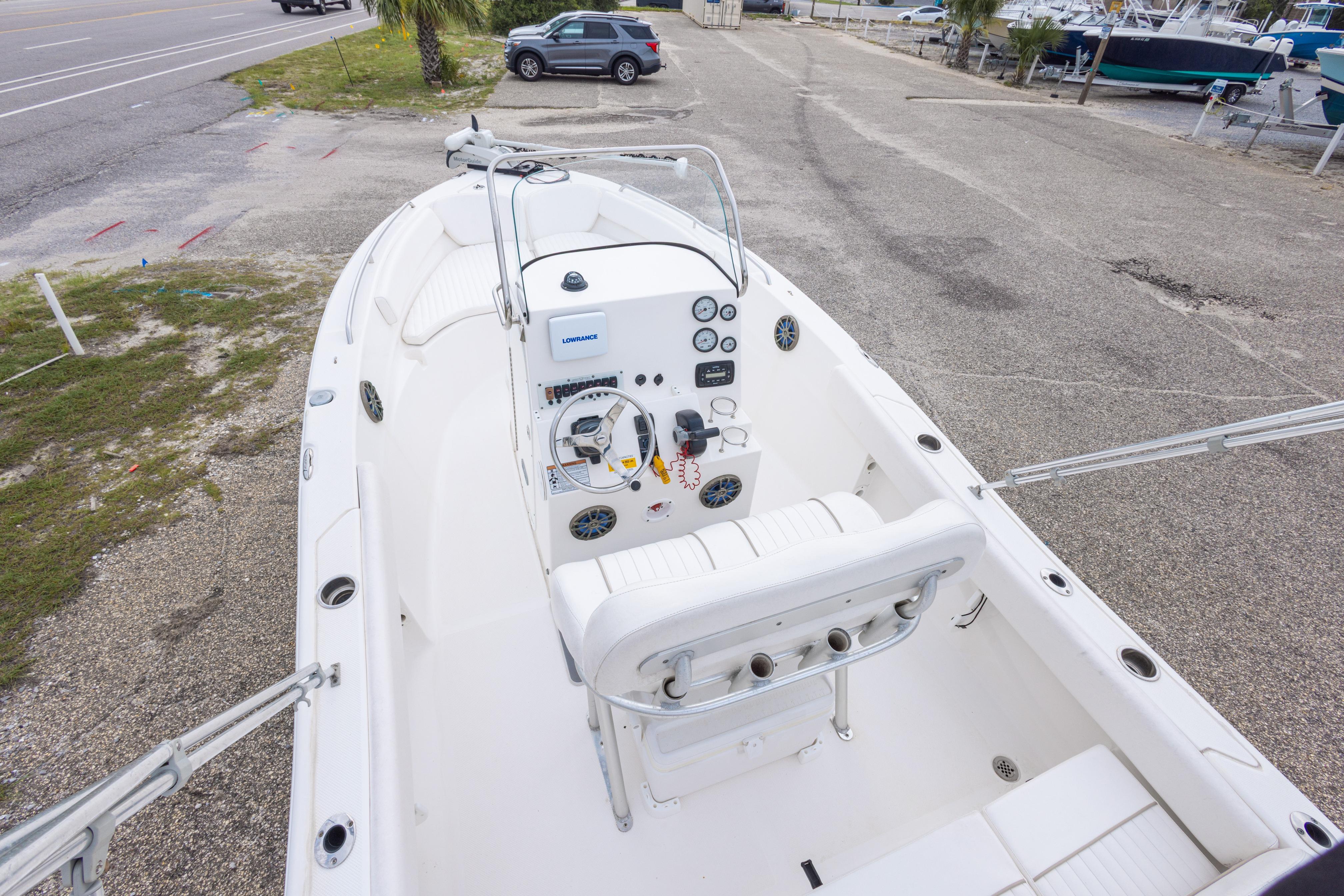 2014 Sea Fox 209 Commander boat interior with steering console and seating, parked on a lot.