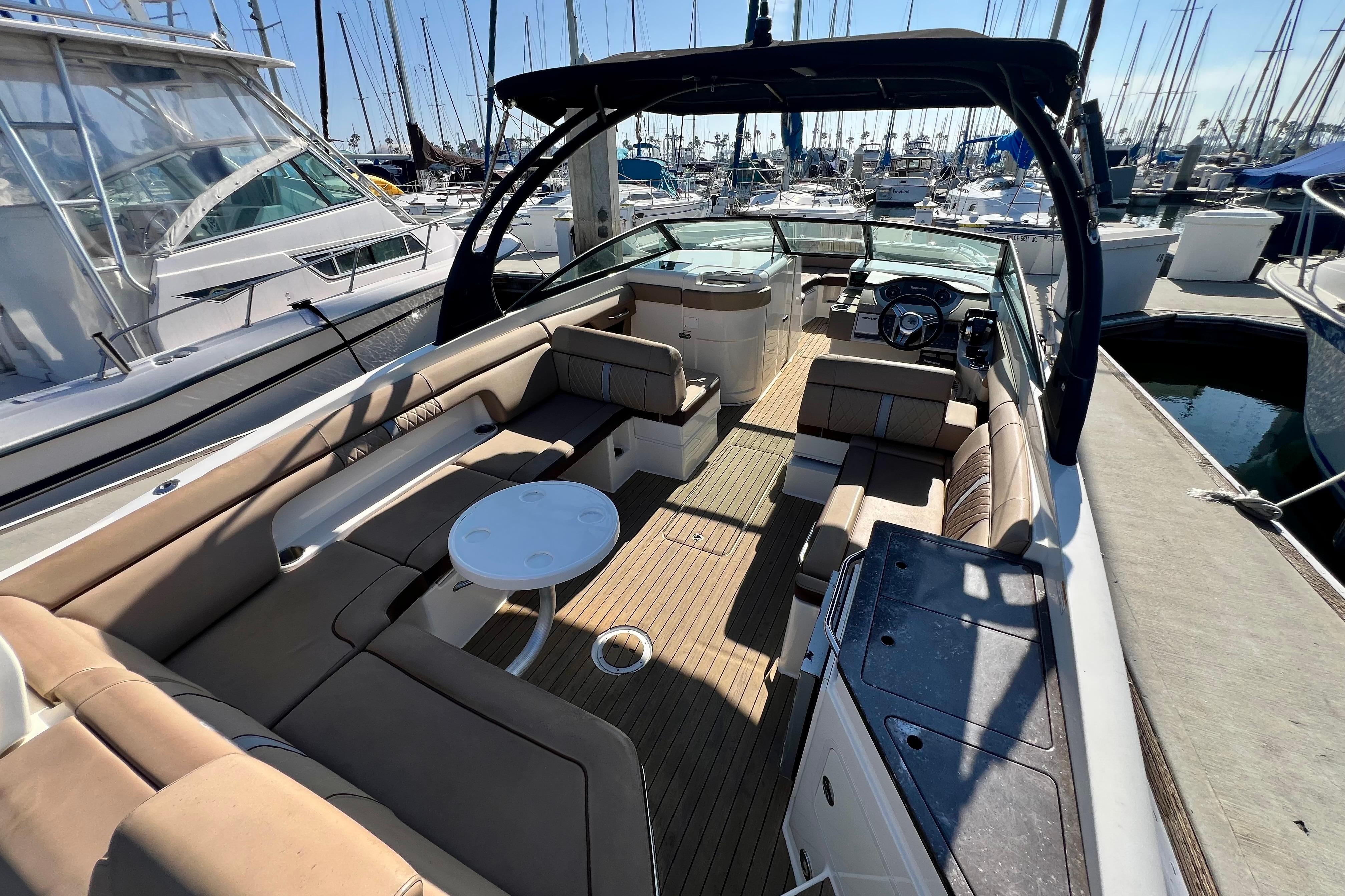 2016 Sea Ray 290 Sundeck Outboard with spacious seating and sleek design in marina.