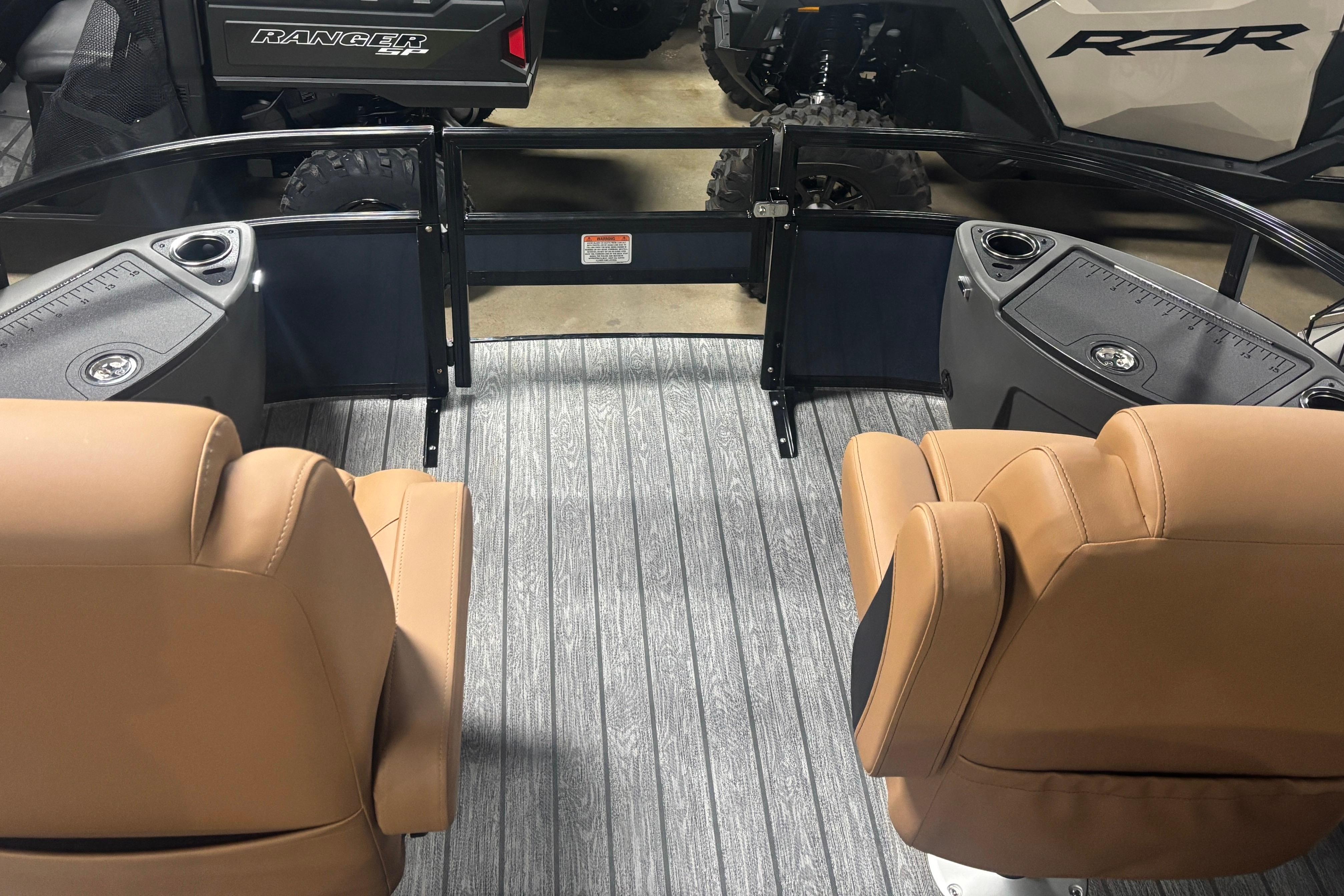 Interior of 2026 Ranger 223F boat with tan seats and gray flooring.