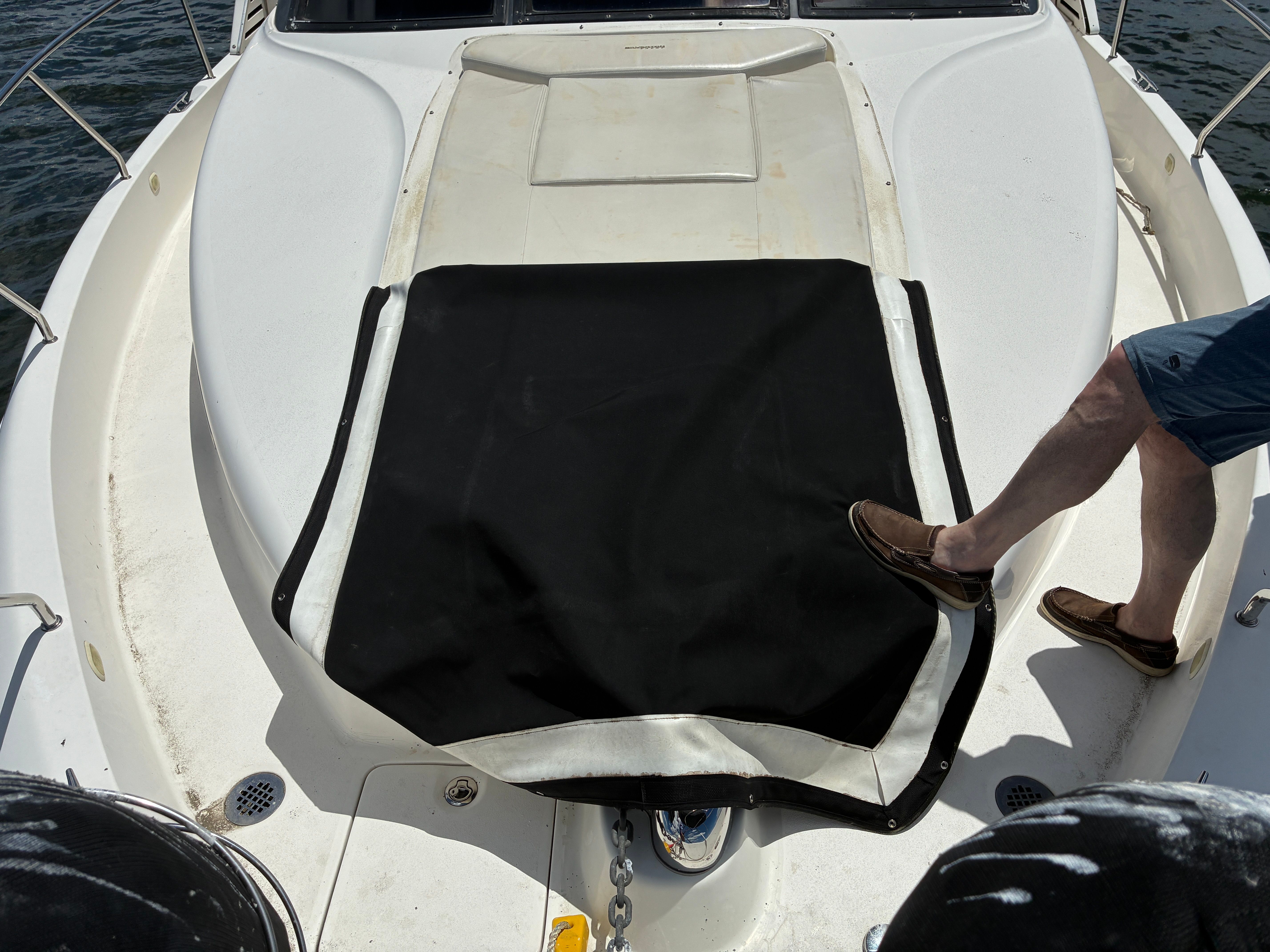 A man stands on the deck of a 2001 Silverton 392 Motor Yacht.