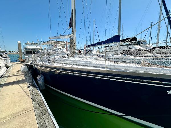 1989 Concordia 52 sailboat docked at marina on a sunny day.