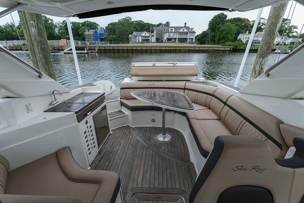 Luxurious 2018 Sea Ray SLX 350 boat interior with elegant seating and waterfront view.
