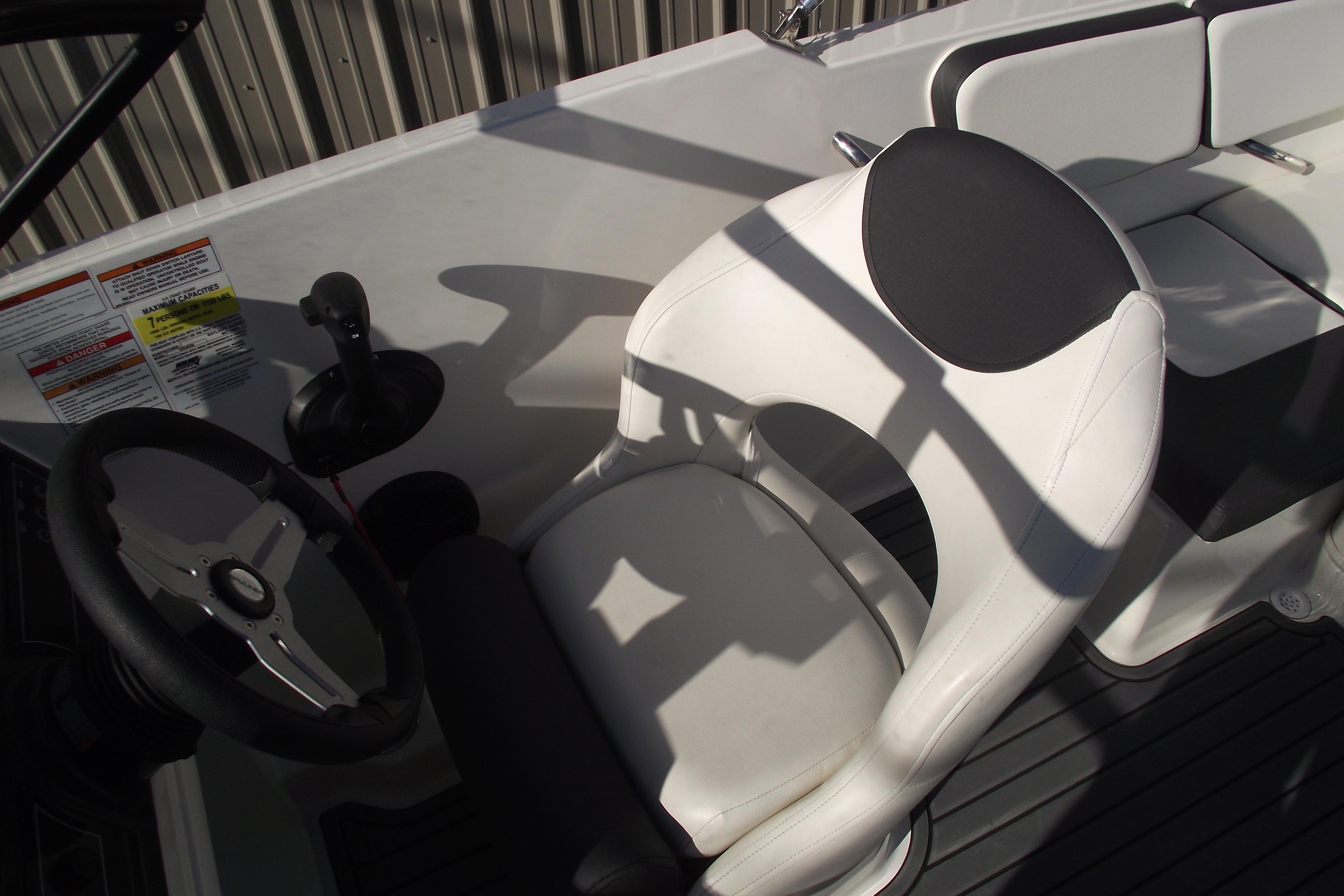 2022 Bayliner VR4 Bowrider OB cockpit with steering wheel and white seating.