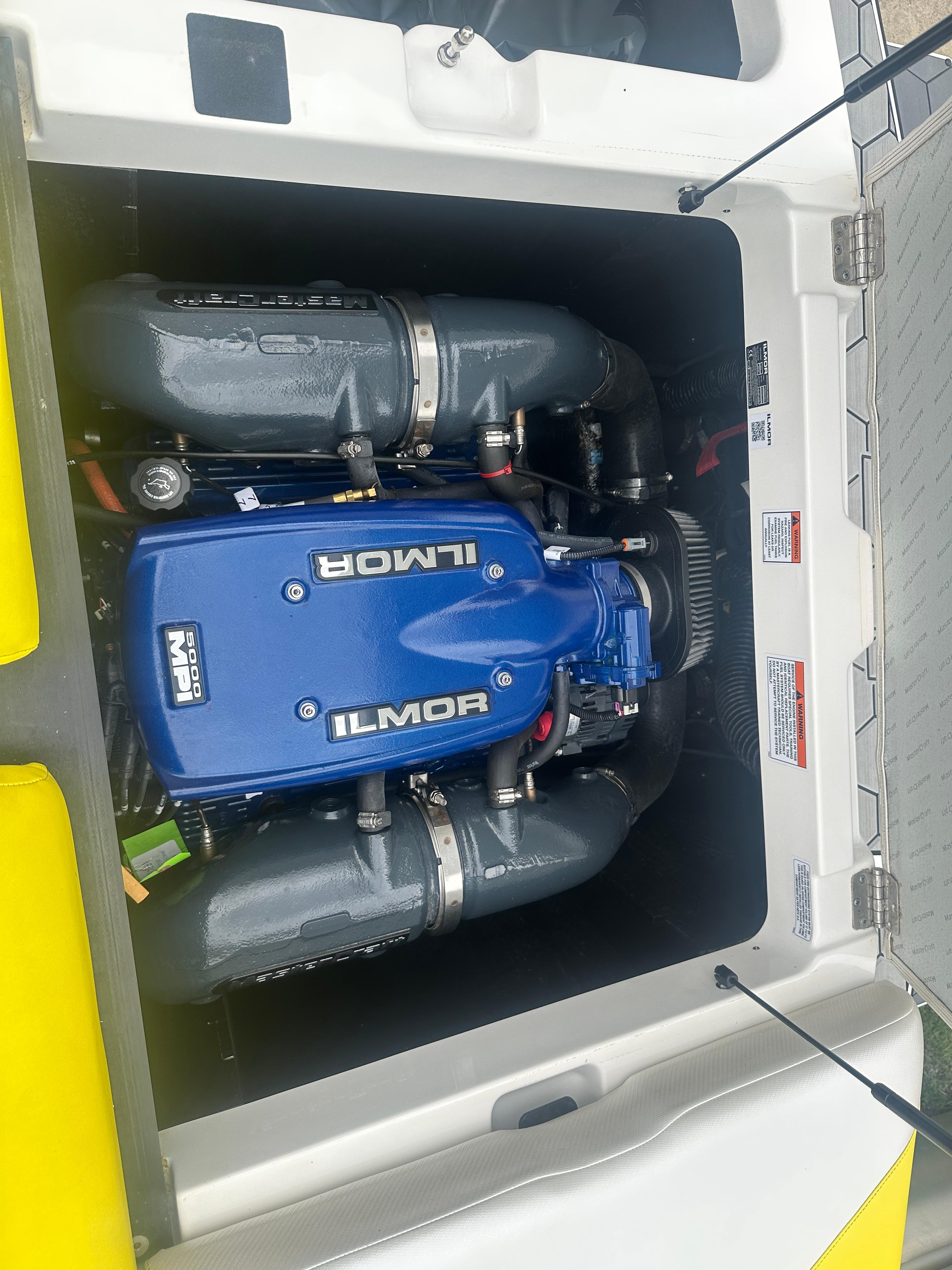 2018 MasterCraft NXT22 boat engine, Ilmor branding, blue cover, detailed view.