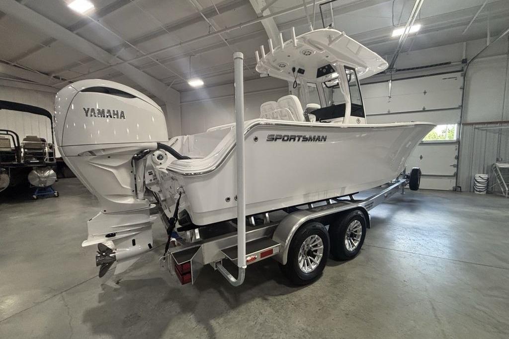 2026 Sportsman Open 252 Center Console boat with Yamaha engine in a garage setting.