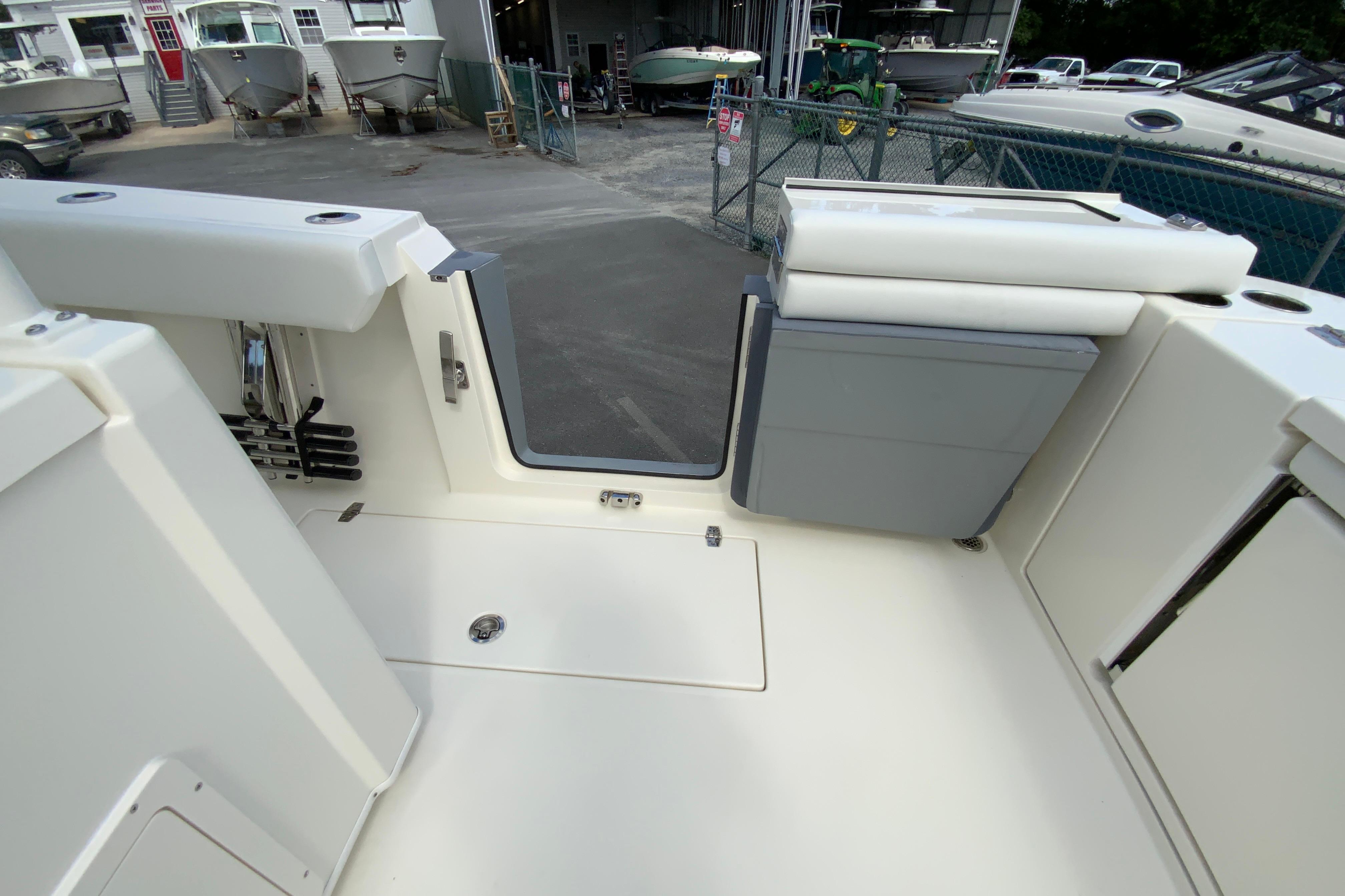 2027 Cobia 320 Center Console boat interior with open deck and storage compartments.