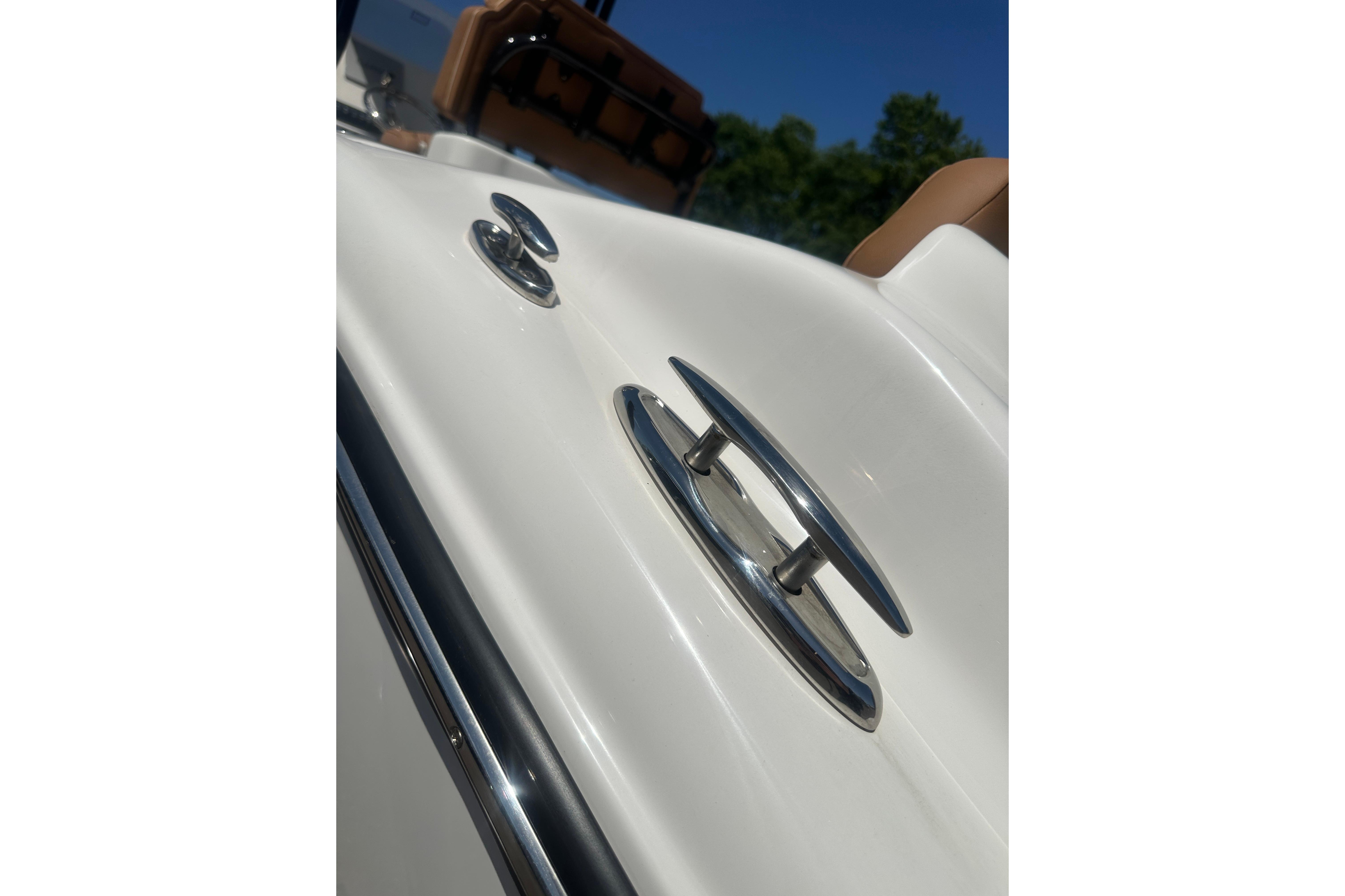 Close-up of 2026 Key West 239 FS boat cleat and railing under clear blue sky.