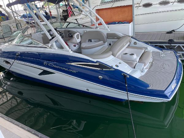 2019 Crownline E255 boat with blue and white exterior docked in marina.