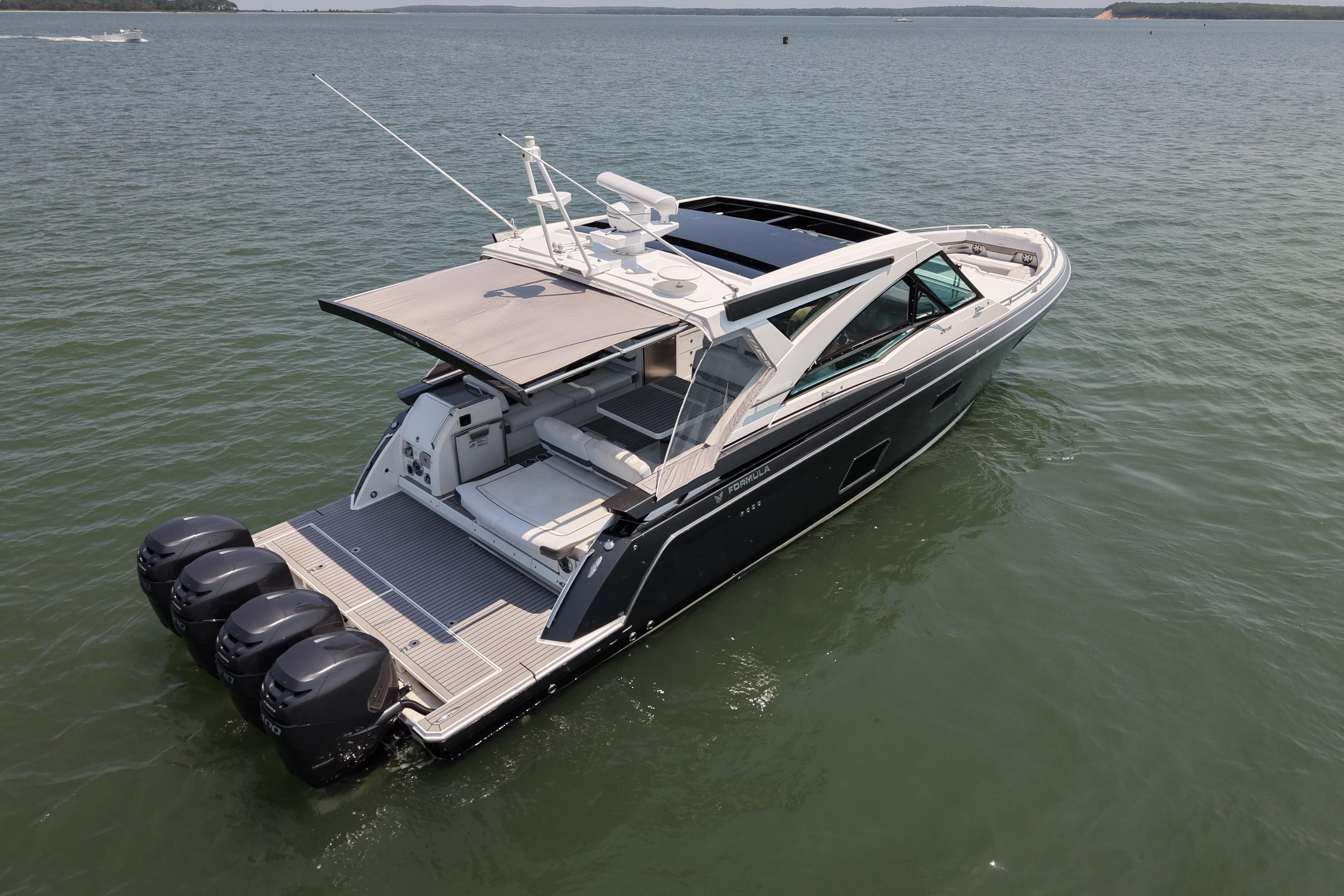 2019 Formula 430 Super Sport Crossover boat on calm water, rear view.