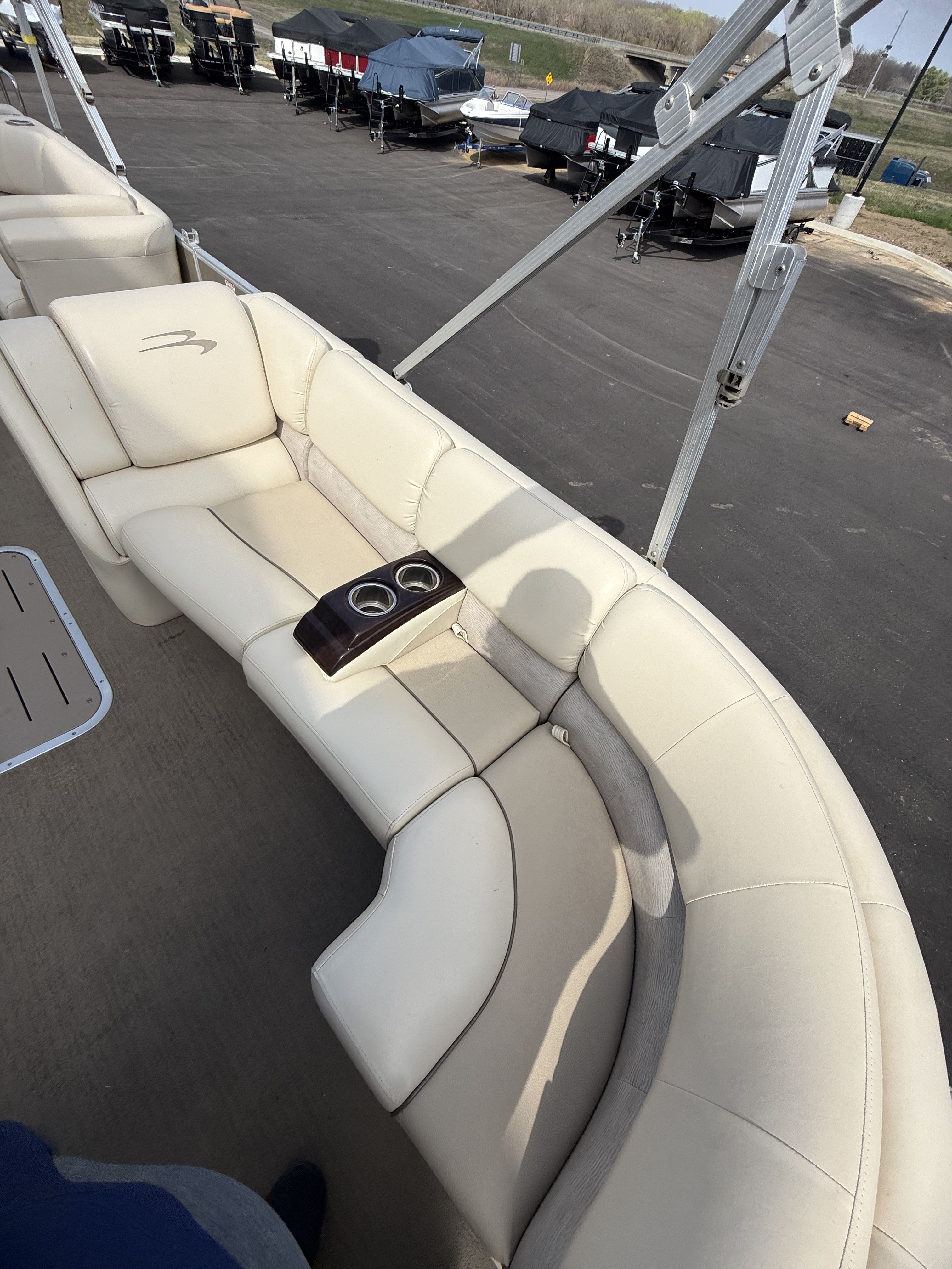 Interior of a 2014 Bennington 2575RCW-I/O with beige leather seating.
