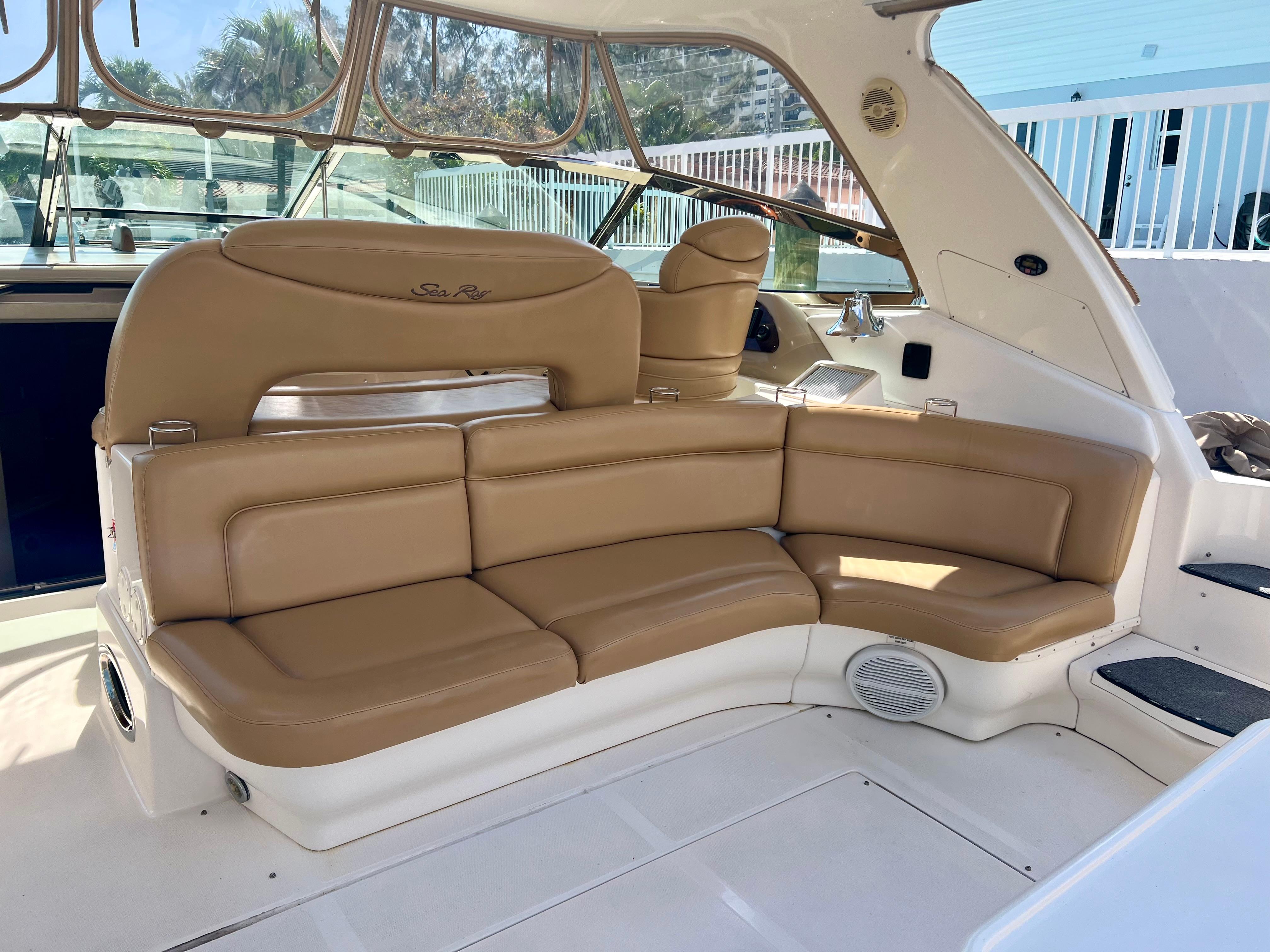 2004 Sea Ray 46 SUNDANCER yacht with tan leather seating in cockpit area.