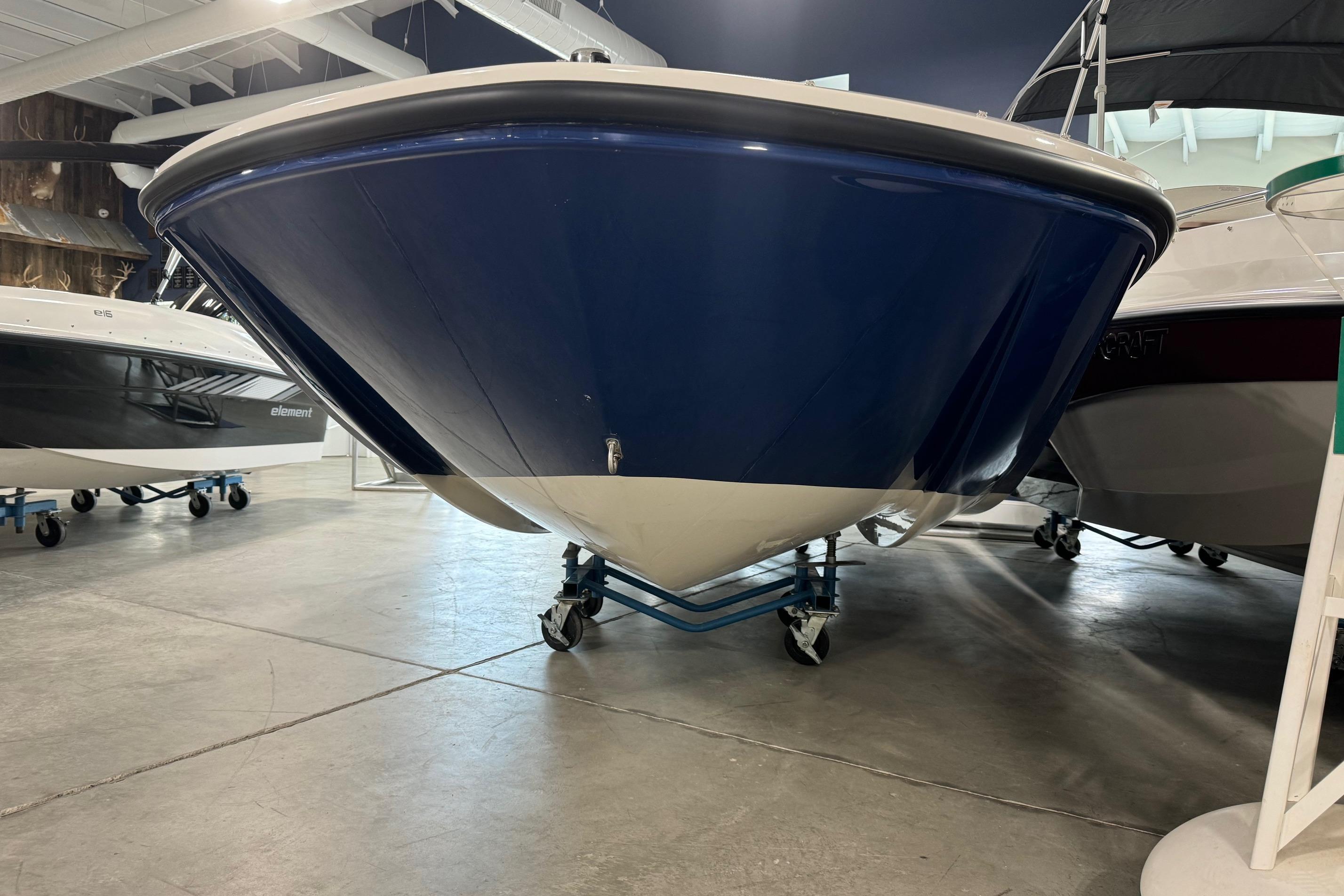 2025 Bayliner Element E18 boat displayed indoors on wheeled supports.