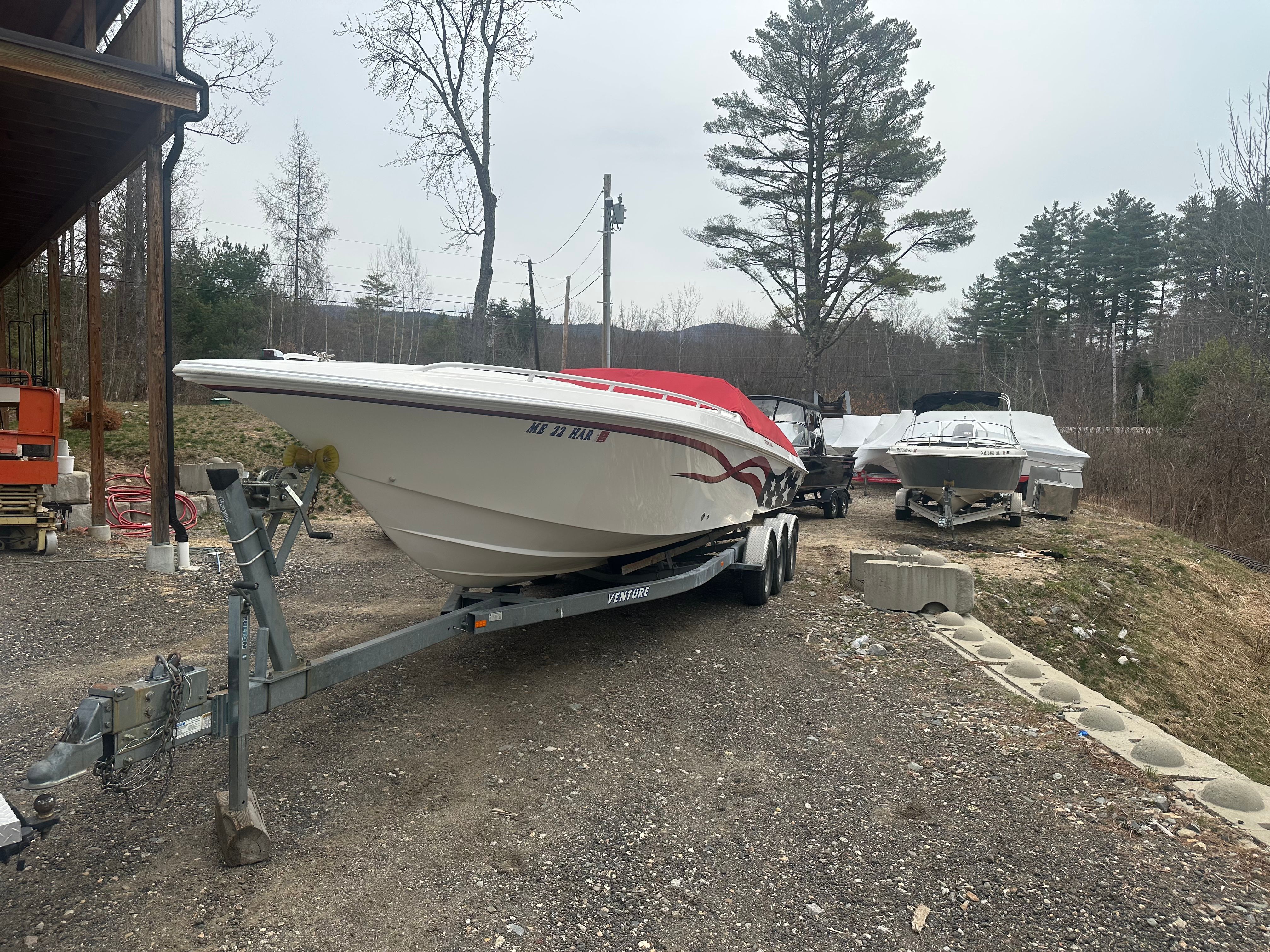 2000 Fountain Fever boat parked on trailer outdoors.